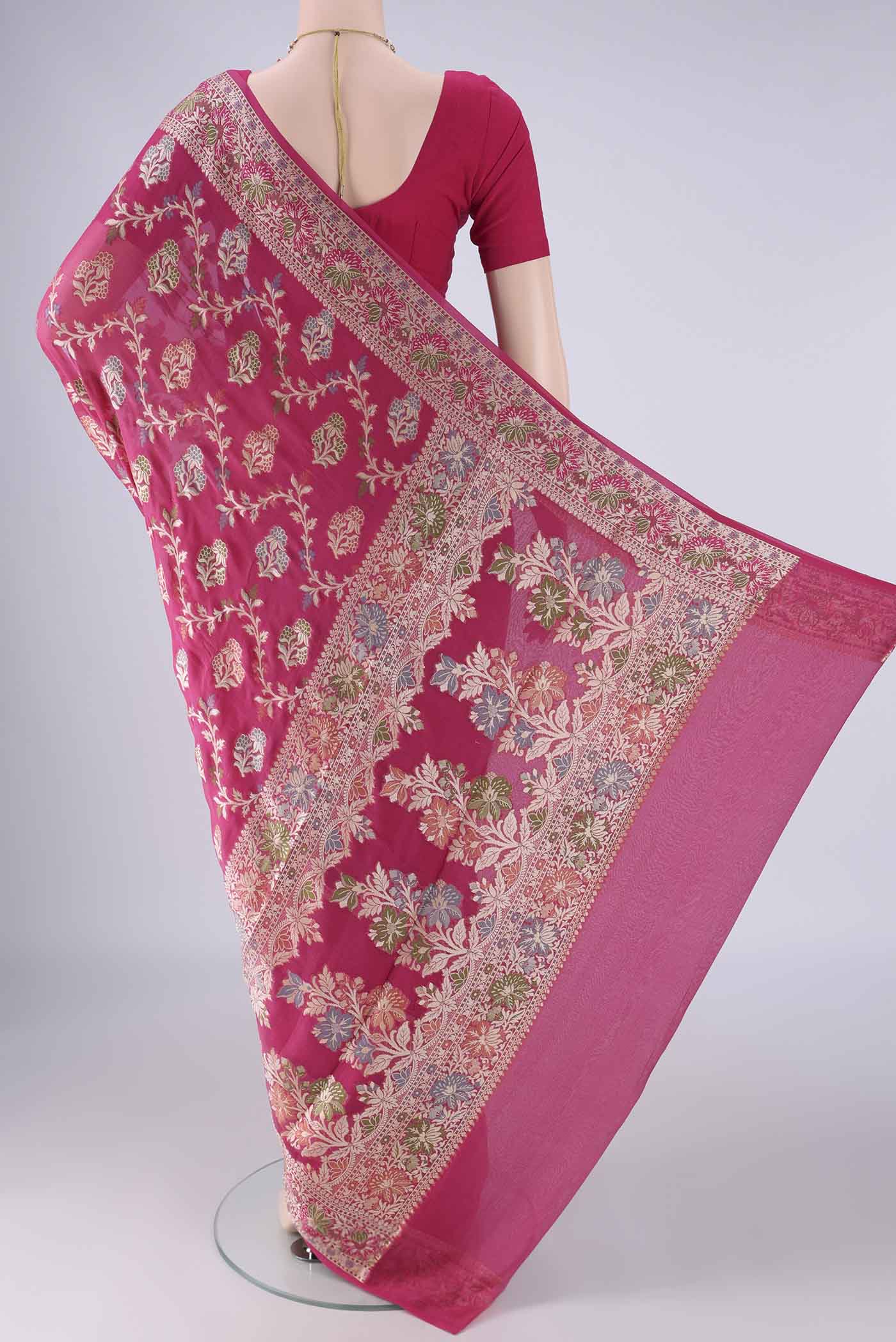 Flat view of Rani Pink Blended Banarasi Georgette Saree with Zari And Thread Butta on the body and Zari And Thread Border. 