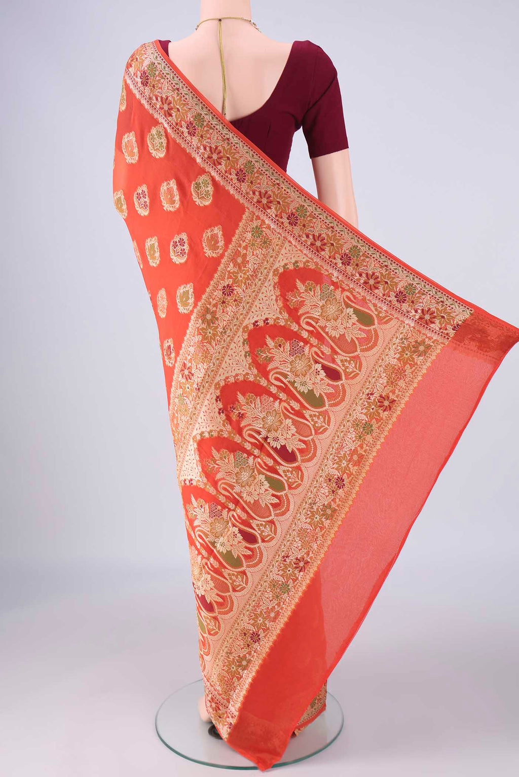 Flat view of Rust Blended Banarasi Georgette Saree with Thread Butta on the body and Zari And Thread Border. 