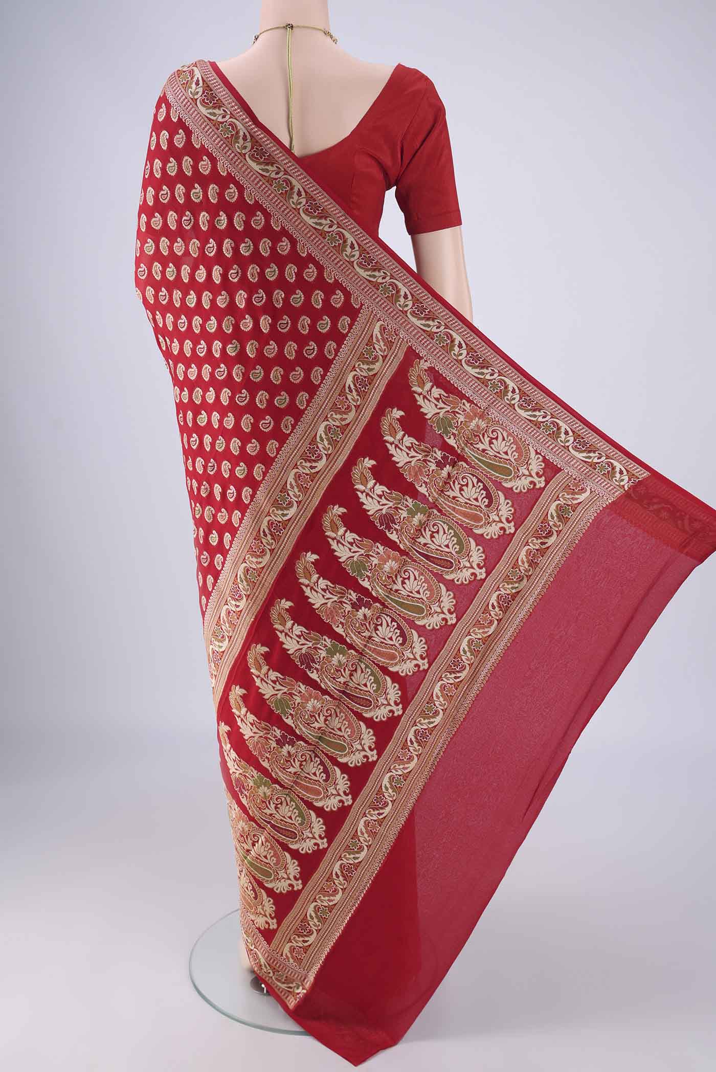Flat view of Red Blended Banarasi Georgette Saree with Thread Butta on the body and Zari And Thread Border. 