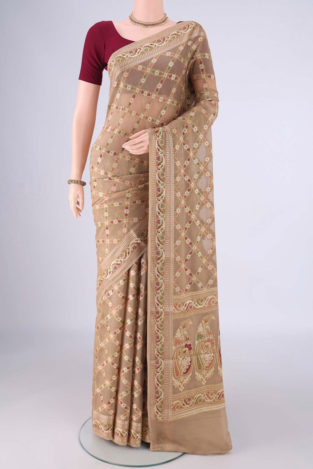 Beige Blended Banarasi Georgette Saree with Thread Brocade on the body and Zari And Thread Border.  displayed on a mannequin