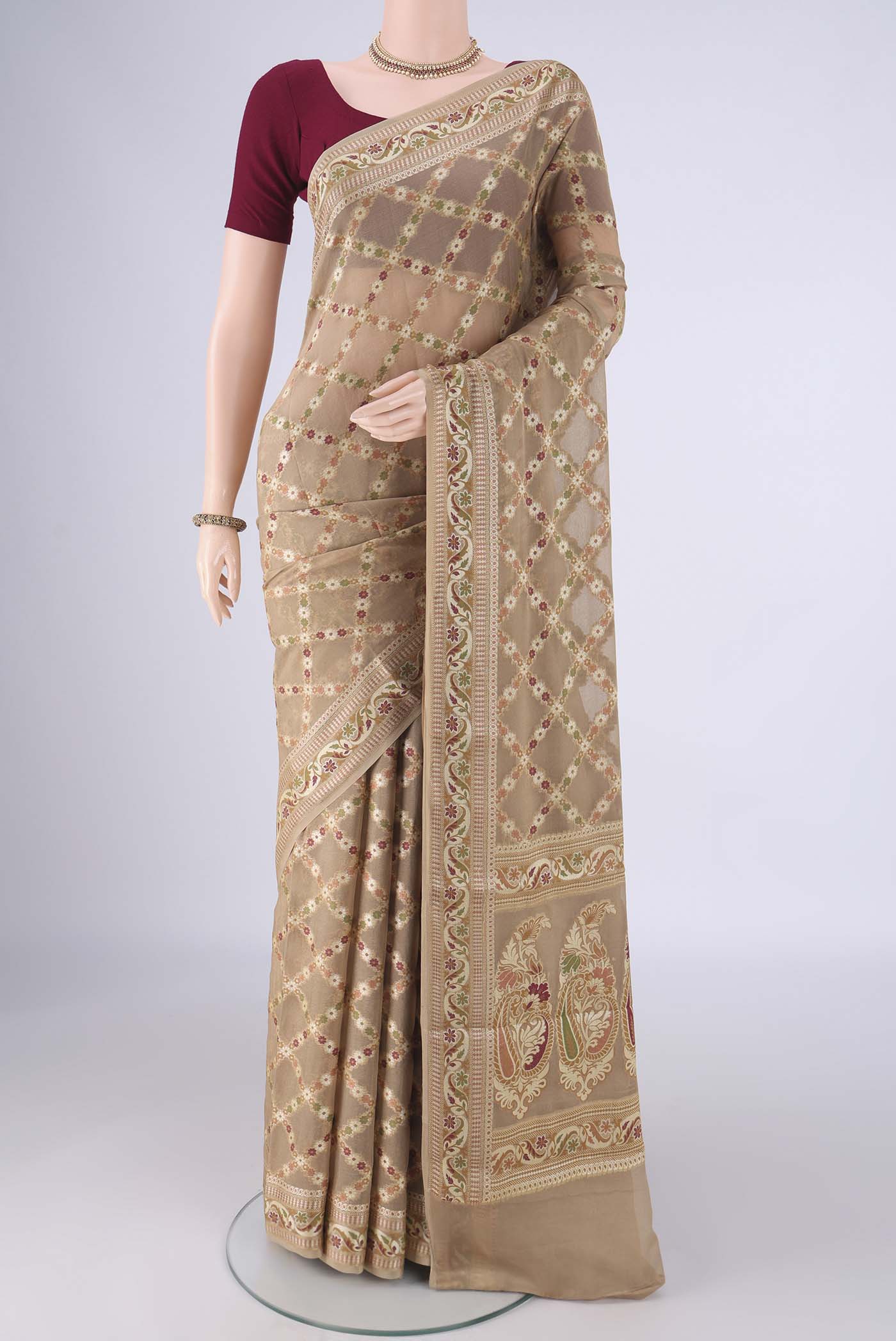 Beige Blended Banarasi Georgette Saree with Thread Brocade on the body and Zari And Thread Border.  displayed on a mannequin