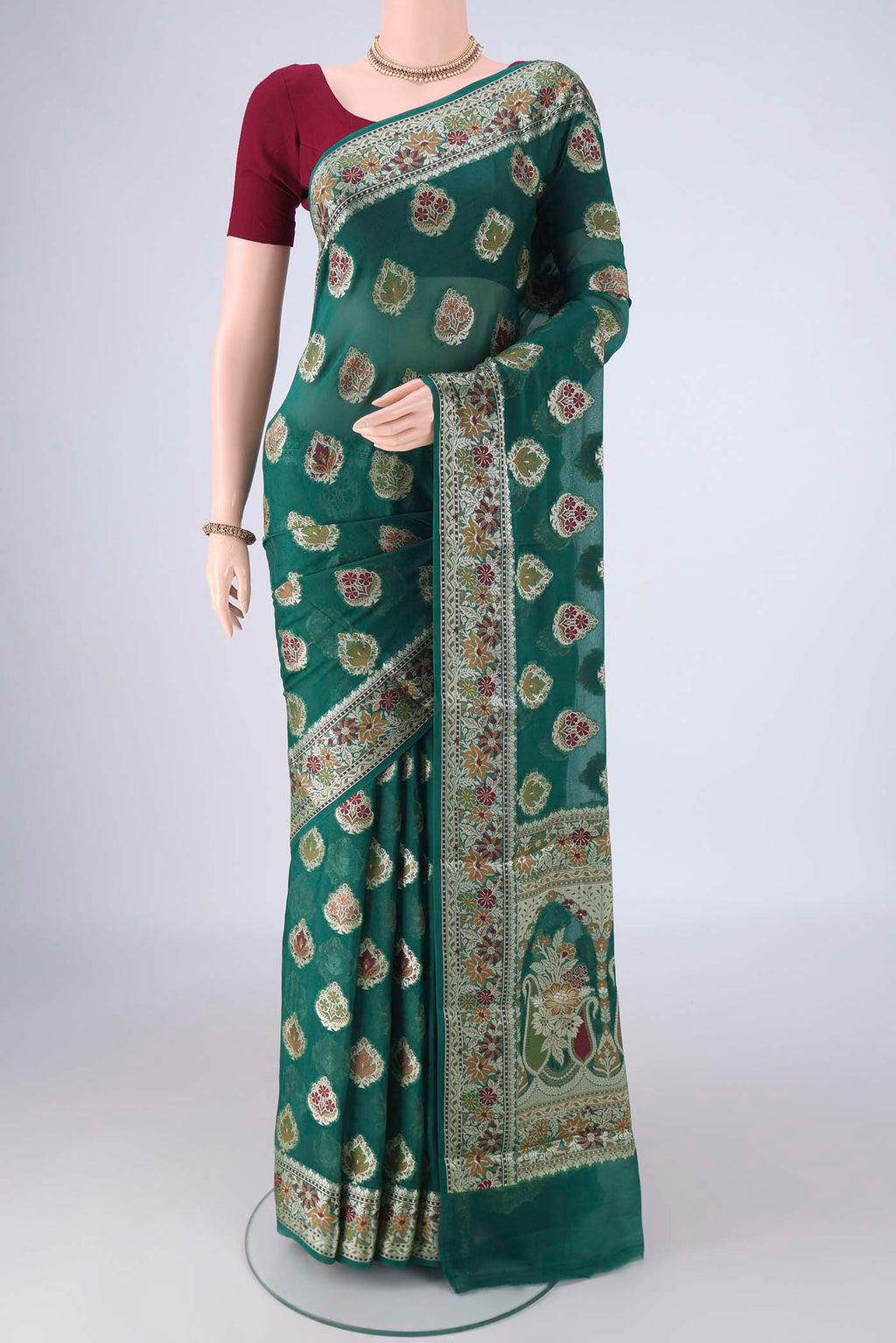 Teal Blended Banarasi Georgette Saree with Thread Butta on the body and Zari And Thread Border.  displayed on a mannequin