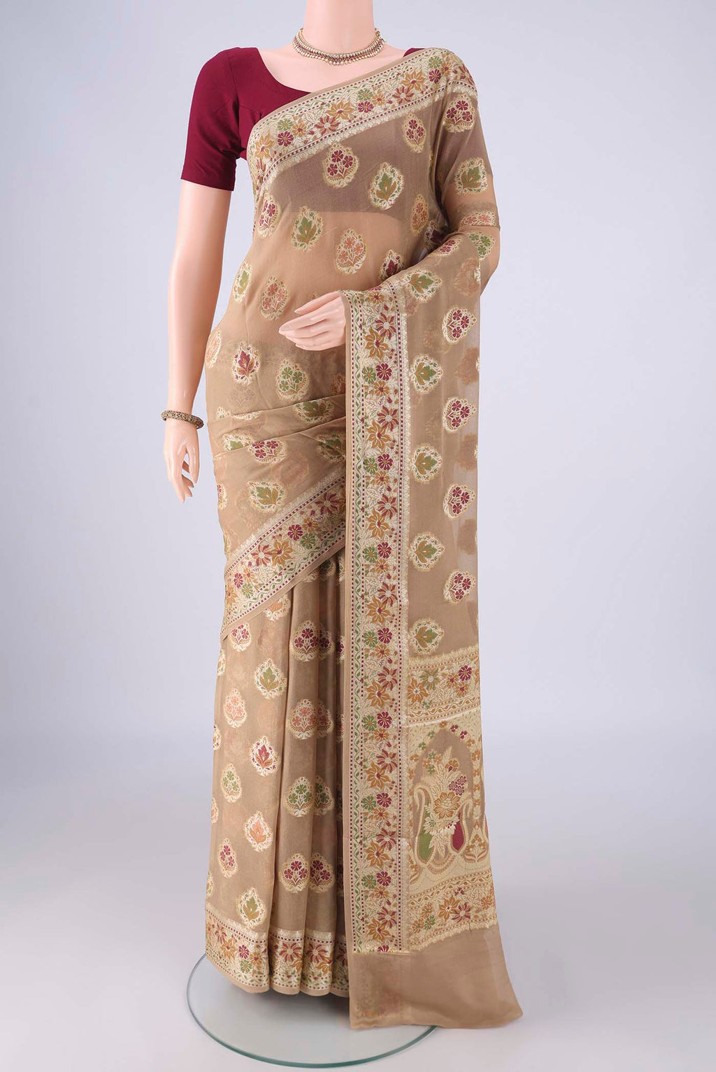 Beige Blended Banarasi Georgette Saree with Zari And Thread Butta on the body and Zari And Thread Border.  displayed on a mannequin