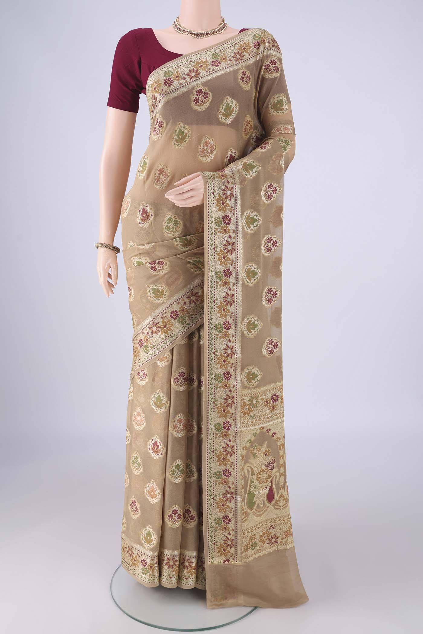 Beige Blended Banarasi Georgette Saree with Zari And Thread Butta on the body and Zari And Thread Border.  displayed on a mannequin