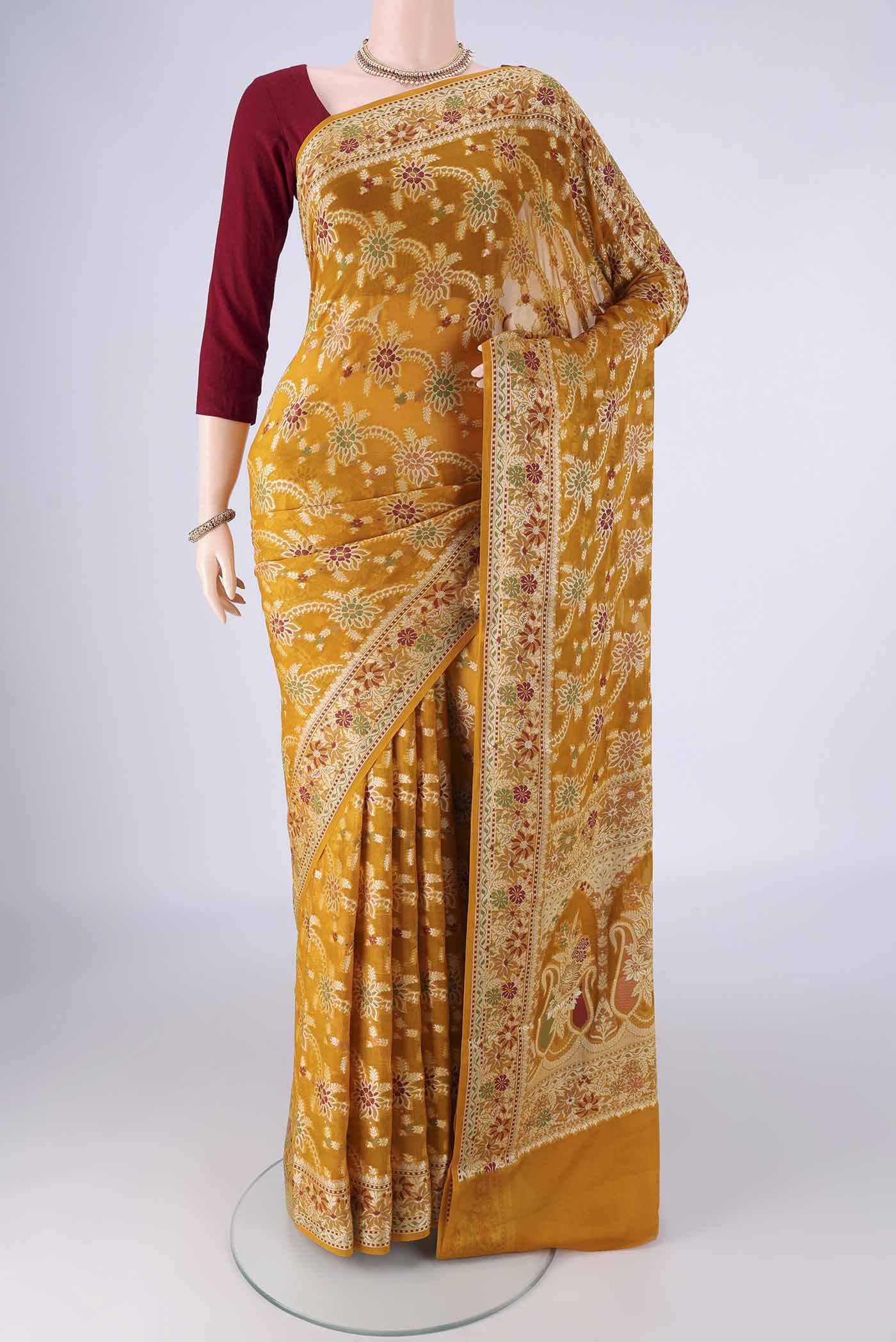 Mustard Blended Banarasi Georgette Saree with Zari Brocade on the body and Zari And Thread Border.  displayed on a mannequin