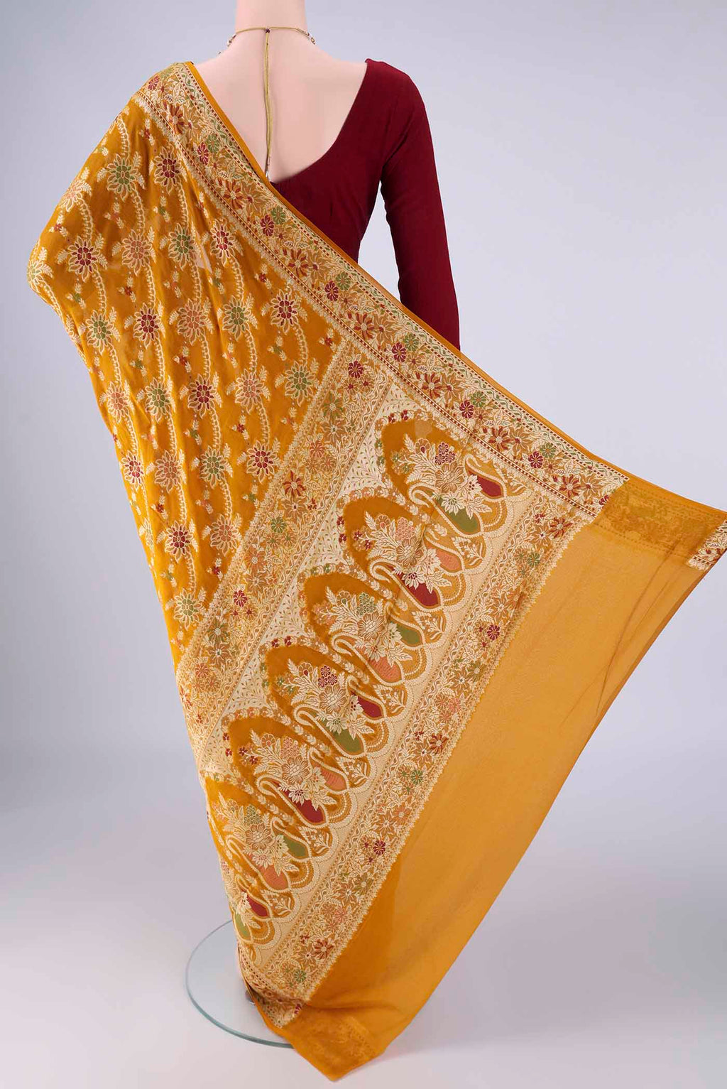 Flat view of Mustard Blended Banarasi Georgette Saree with Zari Brocade on the body and Zari And Thread Border. 