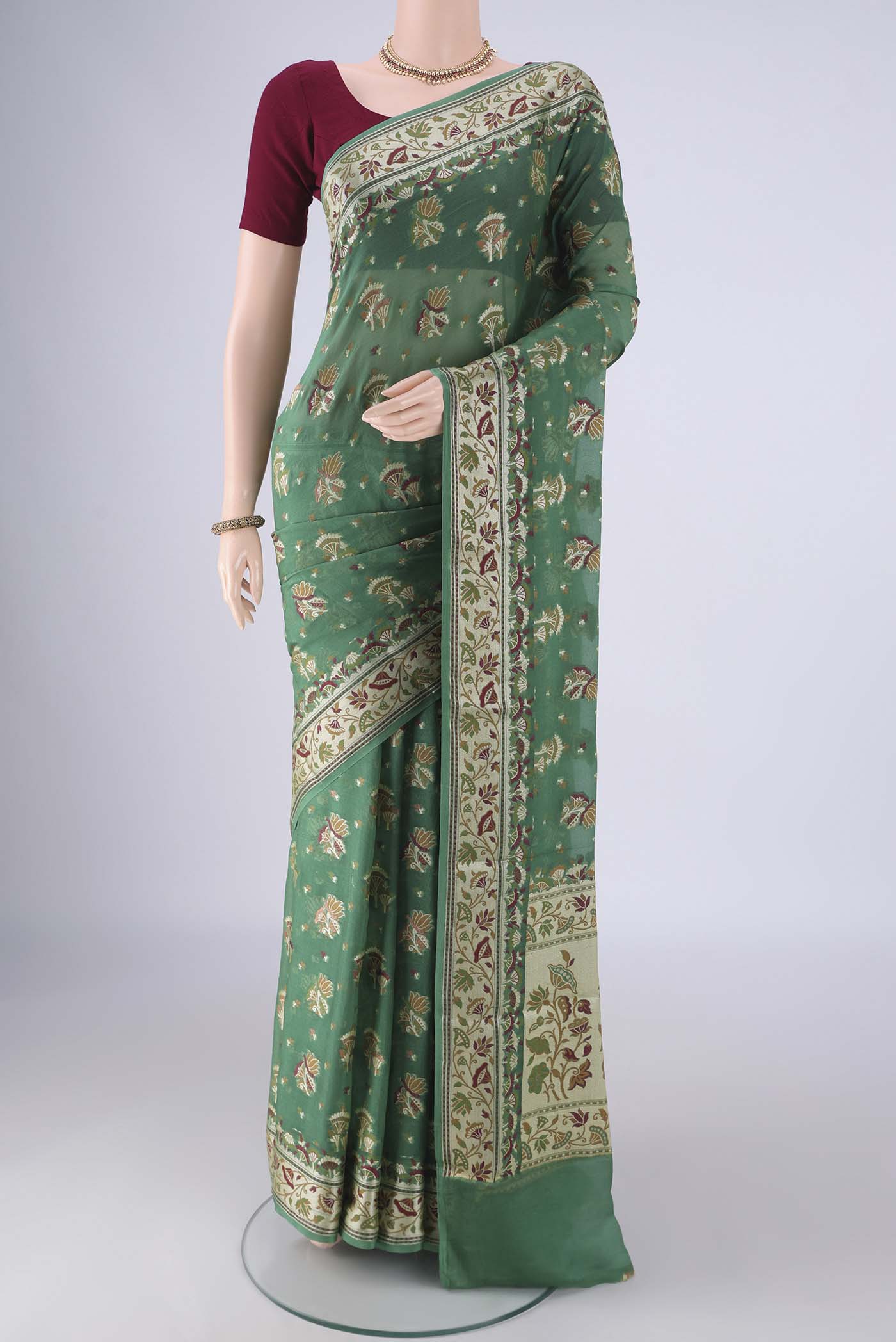 Olive Green Blended Banarasi Georgette Saree with Thread Butta on the body and Zari And Thread Border.  displayed on a mannequin