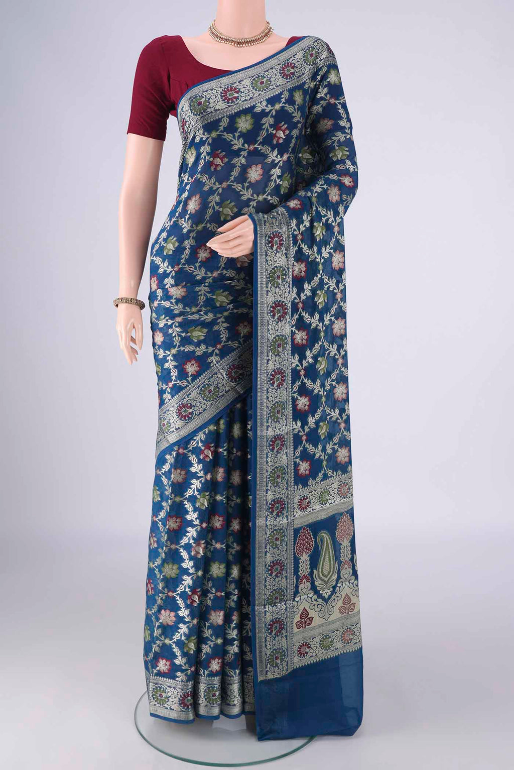 Blue Blended Banarasi Georgette Saree with Zari And Thread Butta on the body and Zari And Thread Border.  displayed on a mannequin