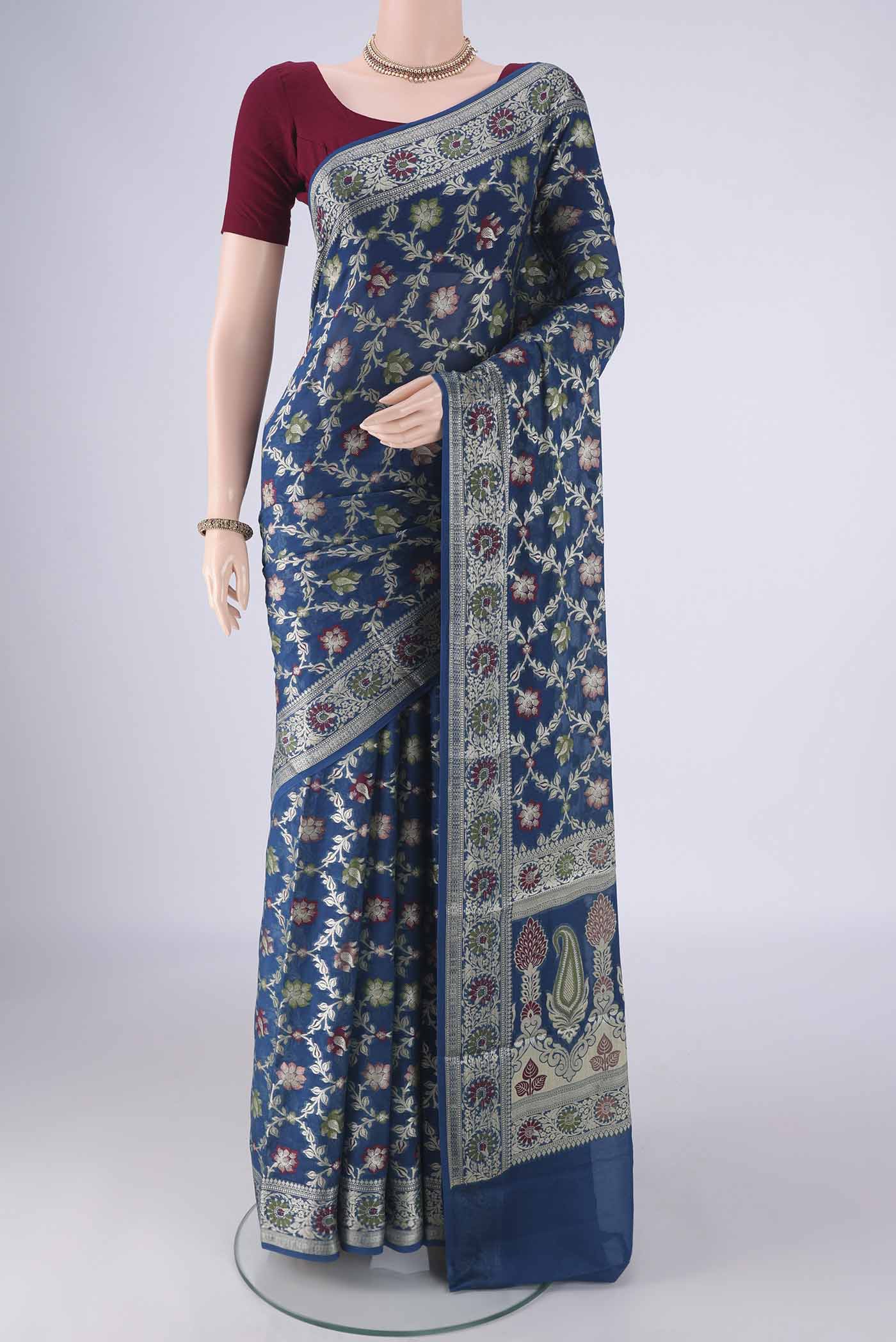 Blue Blended Banarasi Georgette Saree with Zari And Thread Butta on the body and Zari And Thread Border.  displayed on a mannequin