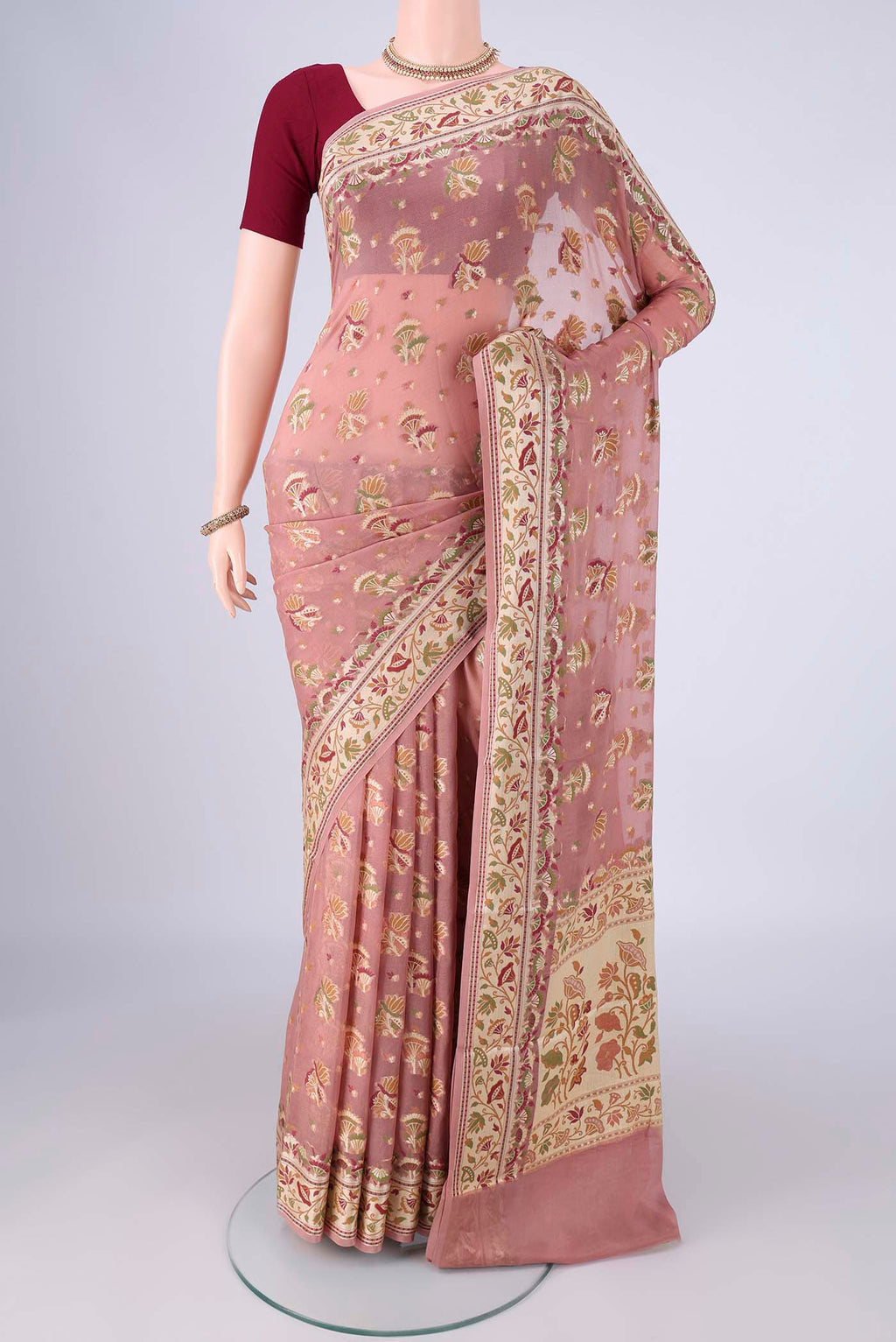Rose Gold Blended Banarasi Georgette Saree with Zari And Thread Butta on the body and Zari And Thread Border.  displayed on a mannequin