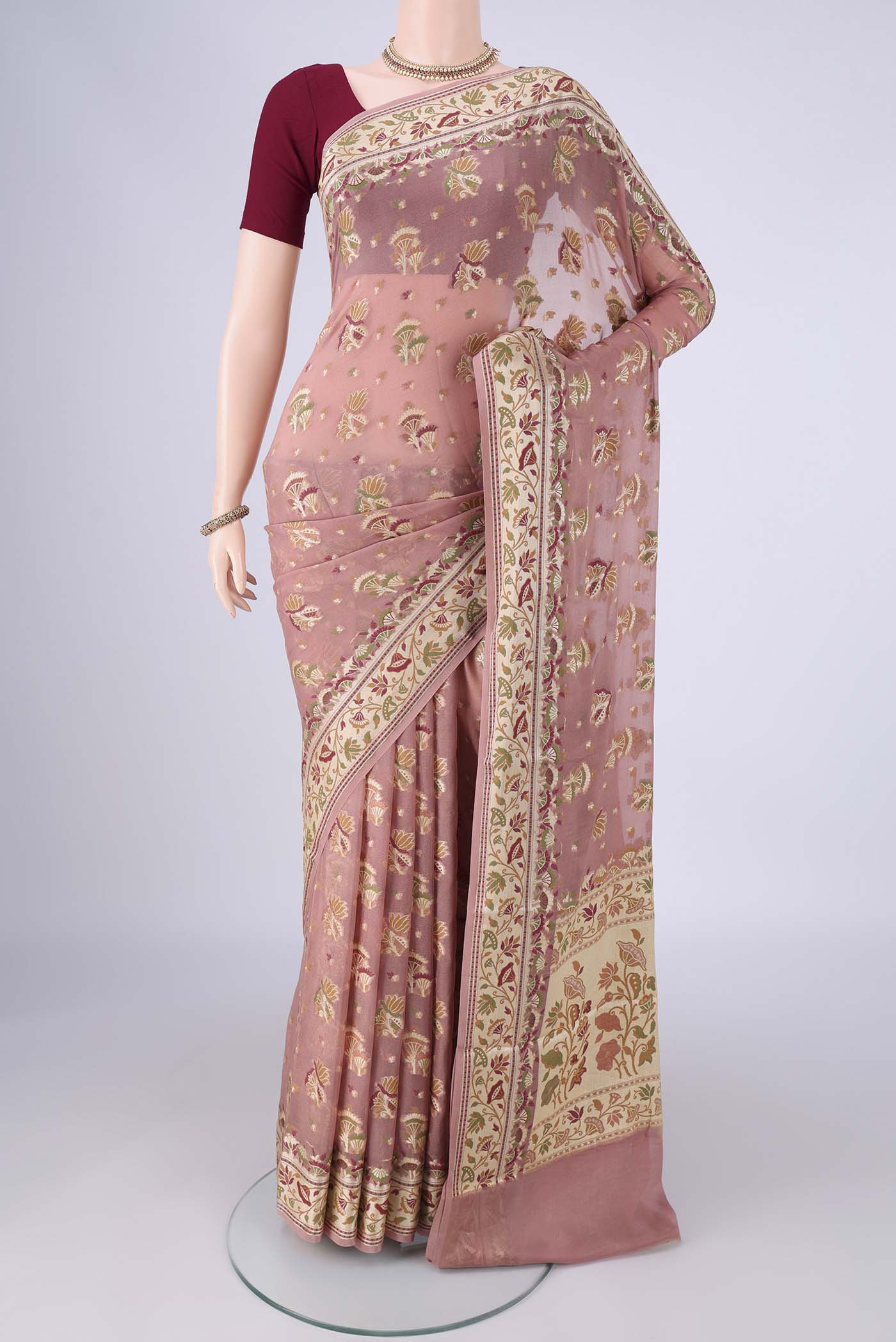 Rose Gold Blended Banarasi Georgette Saree with Zari And Thread Butta on the body and Zari And Thread Border.  displayed on a mannequin