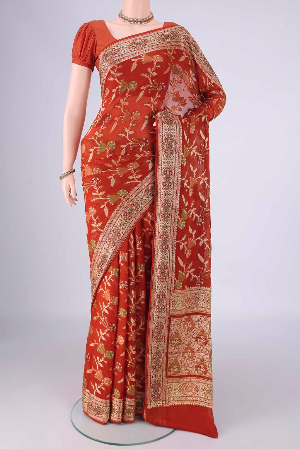 Rust Blended Banarasi Georgette Saree with Thread Brocade on the body and Zari And Thread Border.  displayed on a mannequin