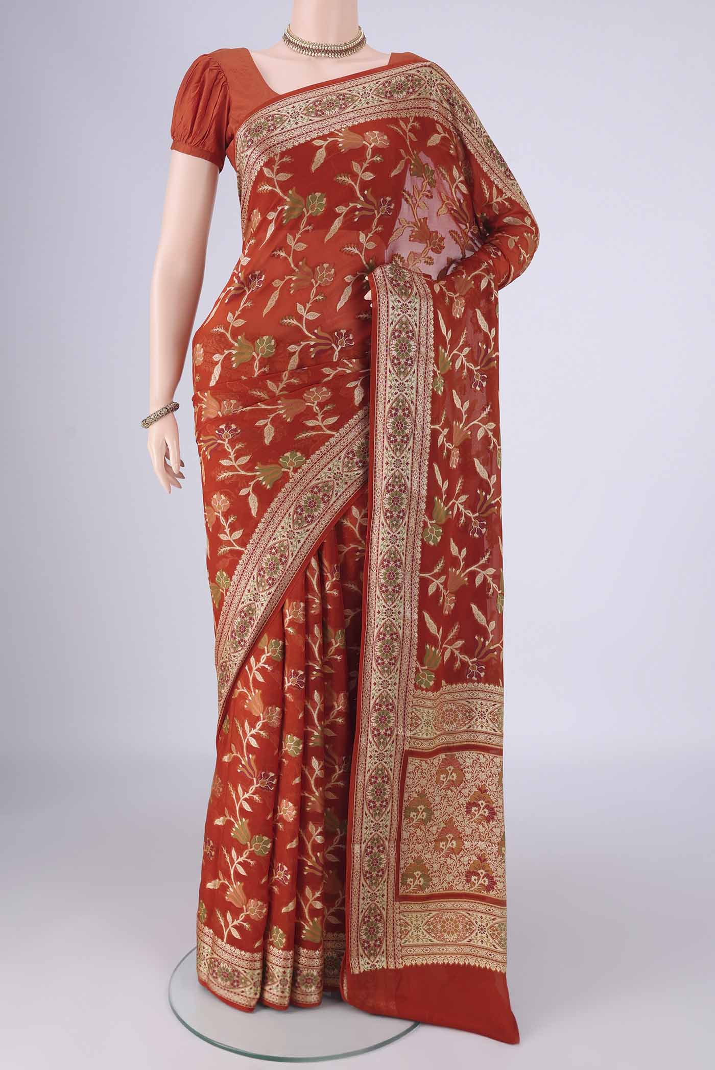 Rust Blended Banarasi Georgette Saree with Thread Brocade on the body and Zari And Thread Border.  displayed on a mannequin