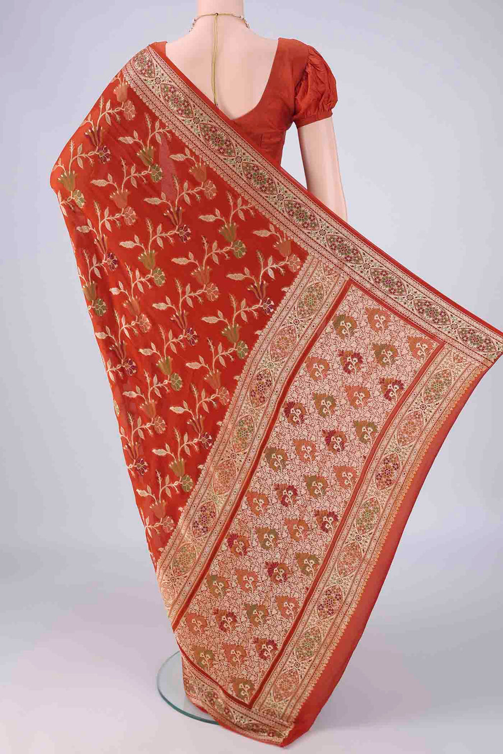 Flat view of Rust Blended Banarasi Georgette Saree with Thread Brocade on the body and Zari And Thread Border. 
