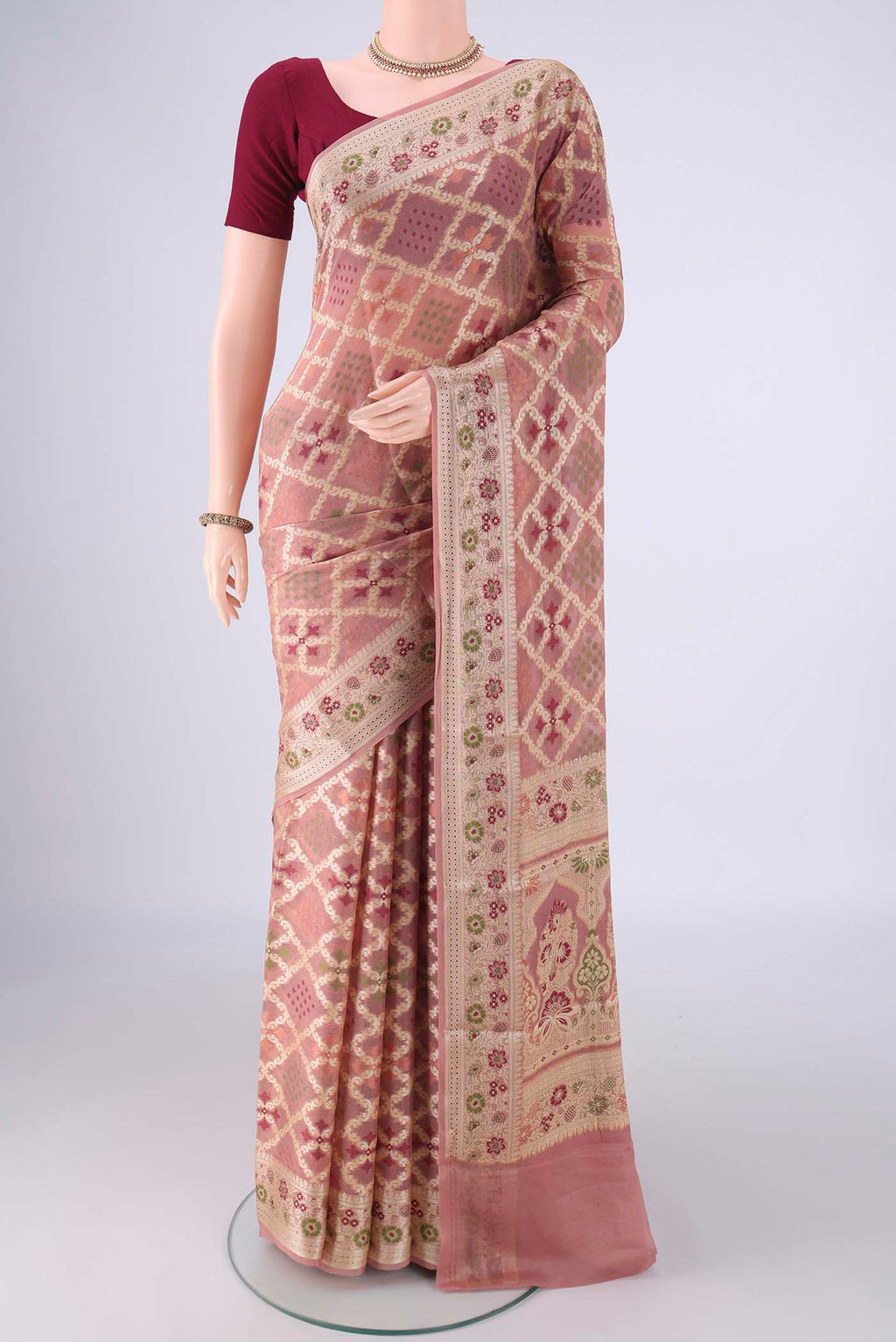 Rose Gold Blended Banarasi Georgette Saree with Zari And Thread Butta on the body and Zari And Thread Border.  displayed on a mannequin