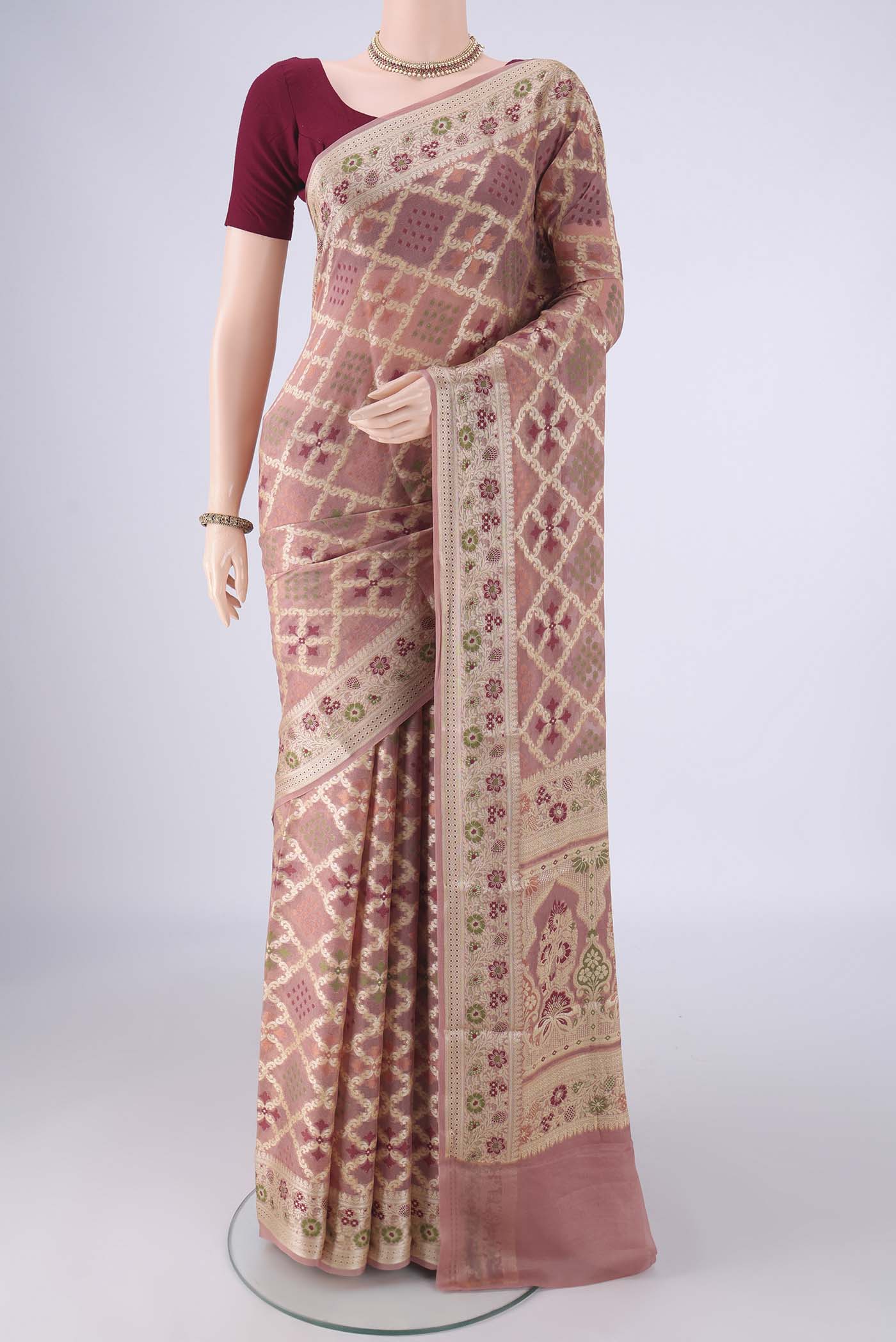 Rose Gold Blended Banarasi Georgette Saree with Zari And Thread Butta on the body and Zari And Thread Border.  displayed on a mannequin