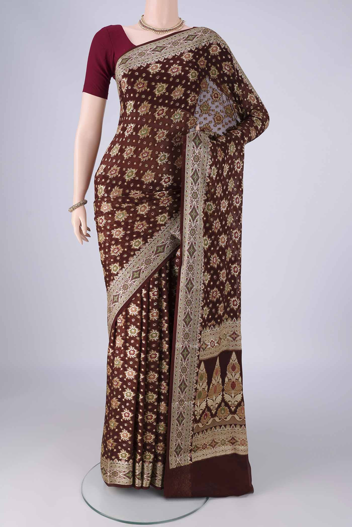 Brown Blended Banarasi Georgette Saree with Zari And Thread Butta on the body and Zari And Thread Border.  displayed on a mannequin