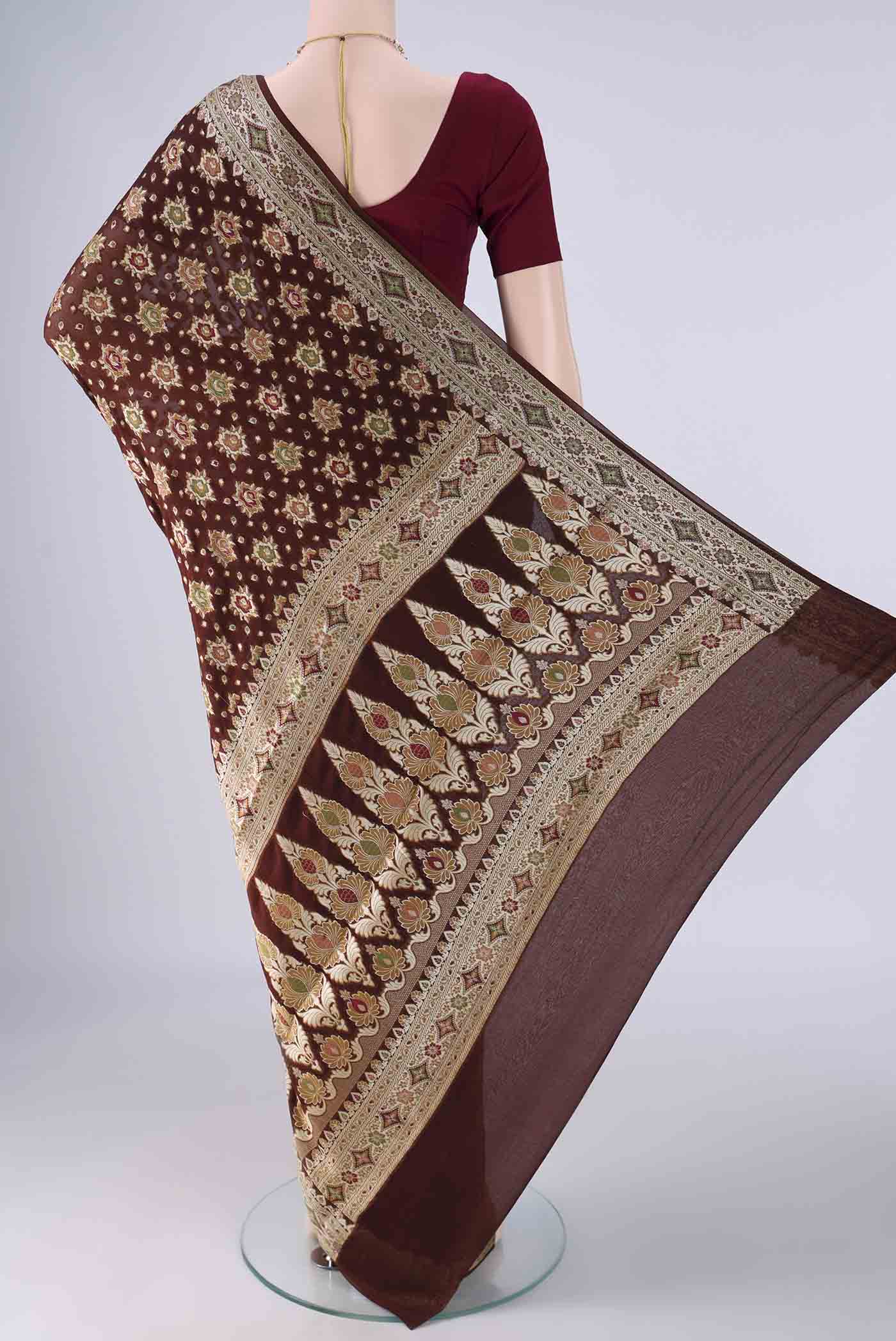 Flat view of Brown Blended Banarasi Georgette Saree with Zari And Thread Butta on the body and Zari And Thread Border. 