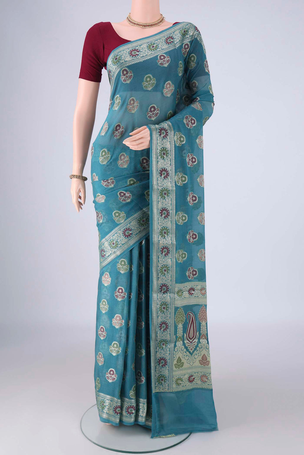 Maya Blue Blended Banarasi Georgette Saree with Thread Butta on the body and Zari And Thread Border.  displayed on a mannequin