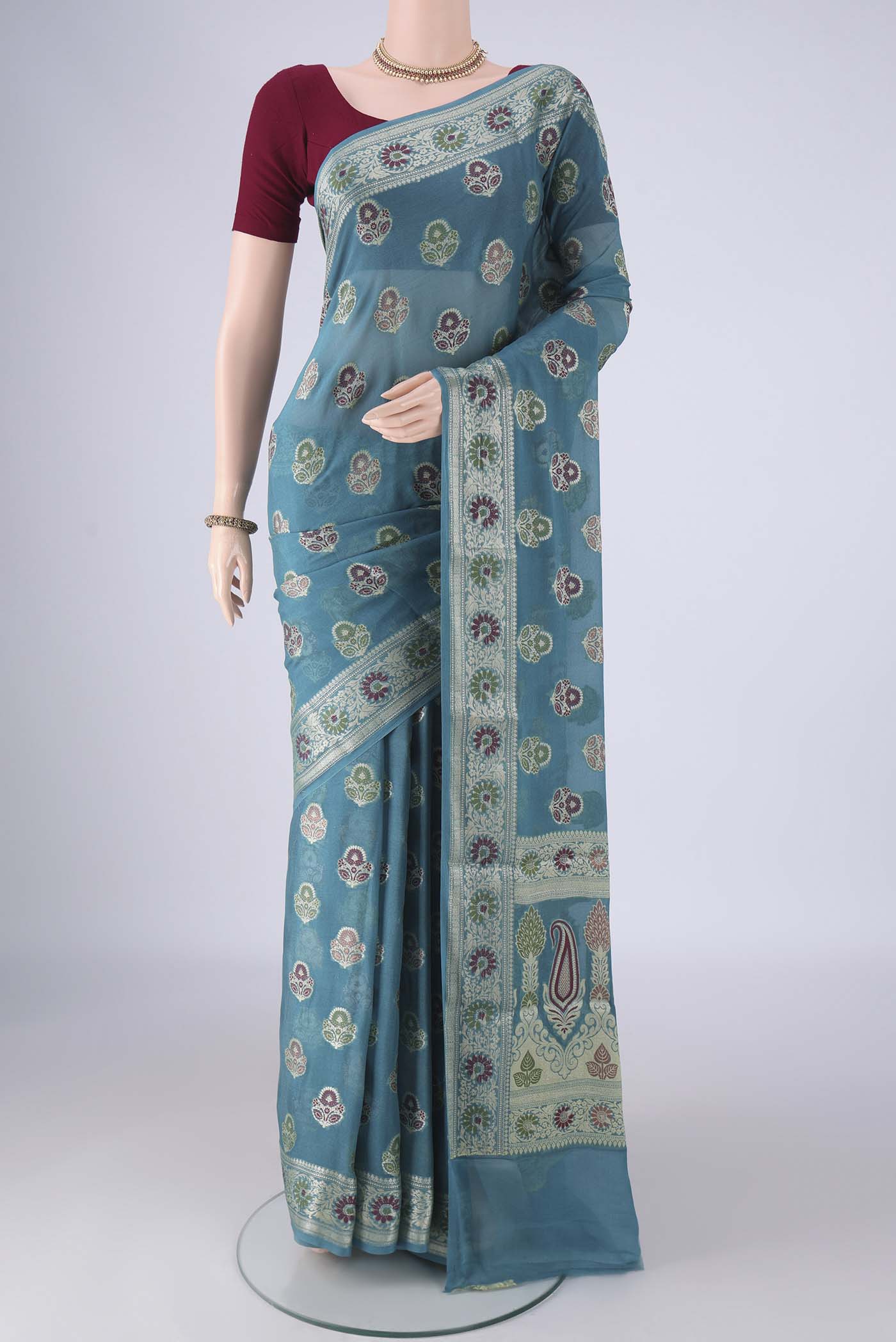 Maya Blue Blended Banarasi Georgette Saree with Thread Butta on the body and Zari And Thread Border.  displayed on a mannequin