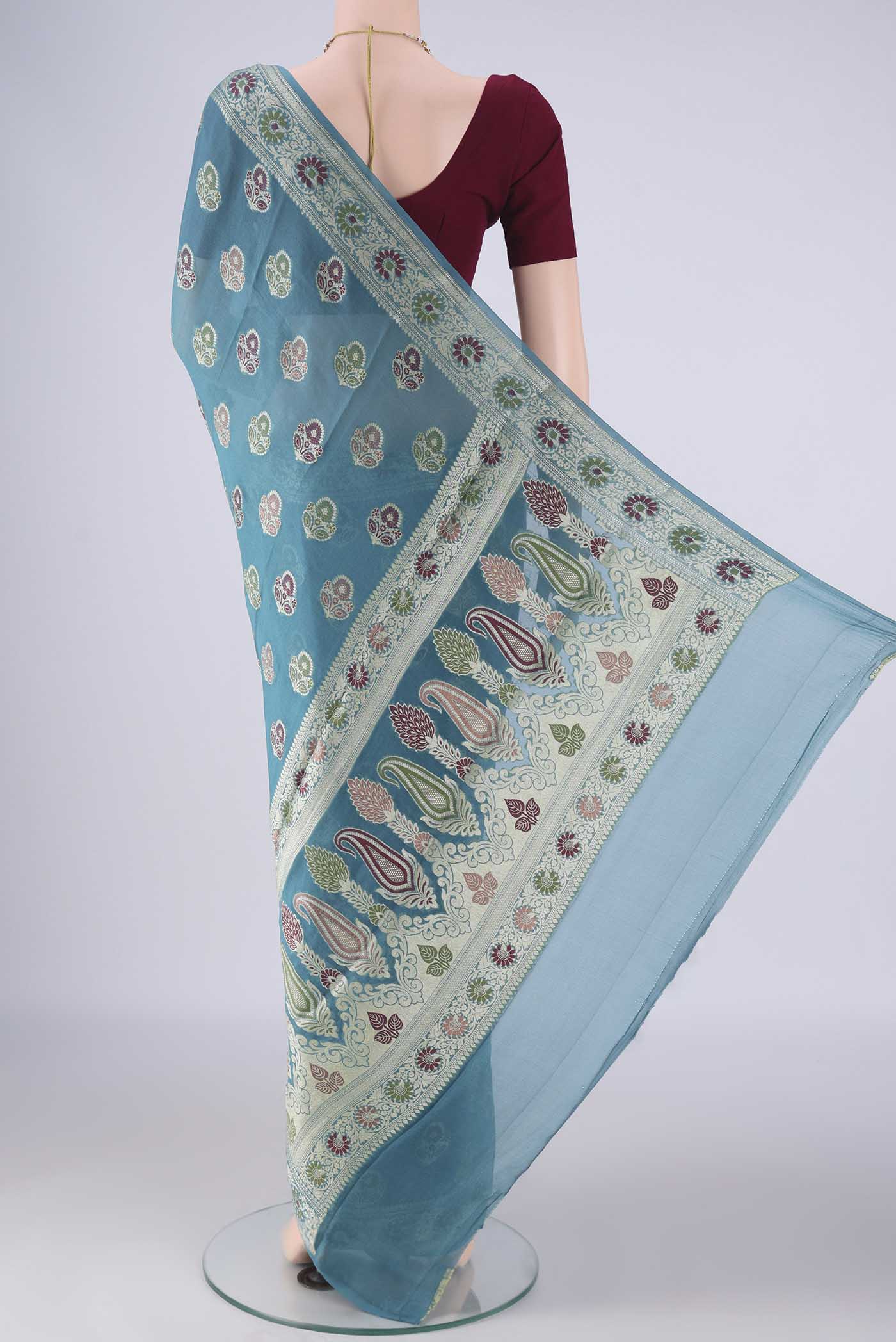 Flat view of Maya Blue Blended Banarasi Georgette Saree with Thread Butta on the body and Zari And Thread Border. 