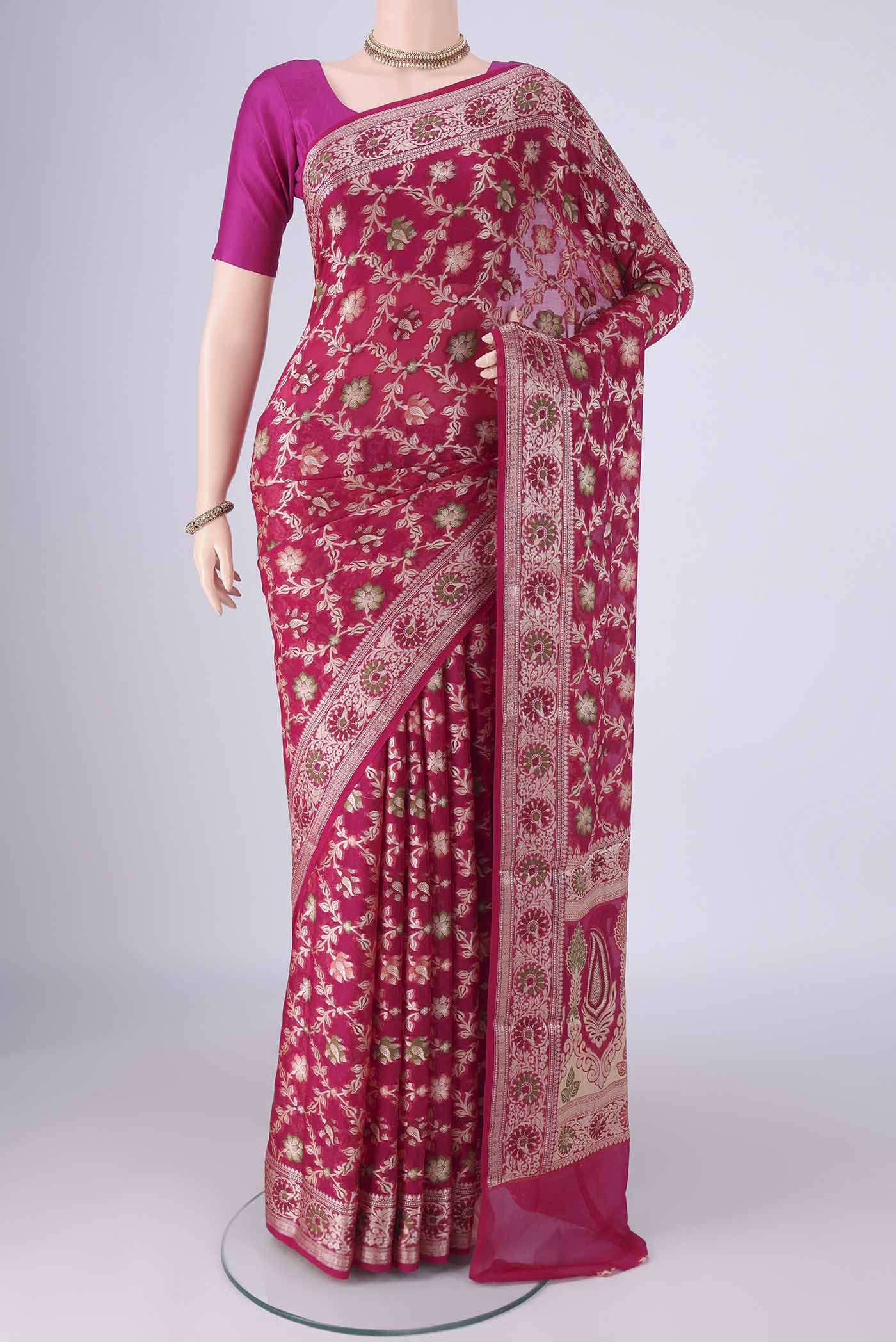 Rani Pink Blended Banarasi Georgette Saree with Thread Brocade on the body and Zari And Thread Border.  displayed on a mannequin