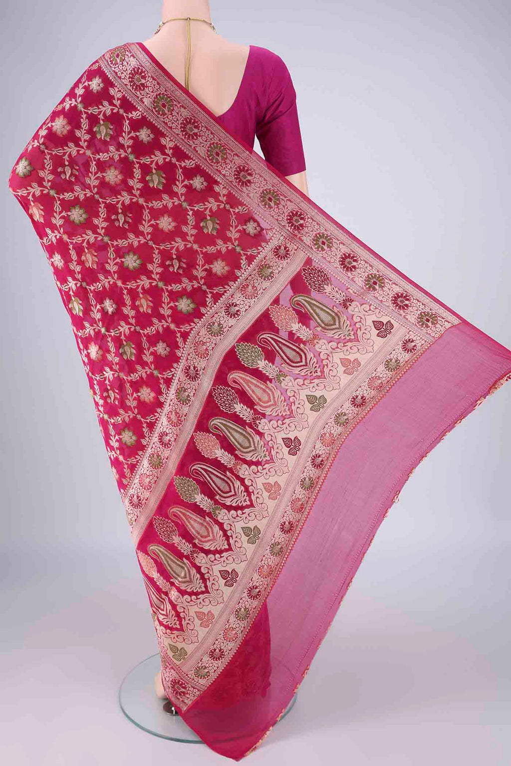 Flat view of Rani Pink Blended Banarasi Georgette Saree with Thread Brocade on the body and Zari And Thread Border. 