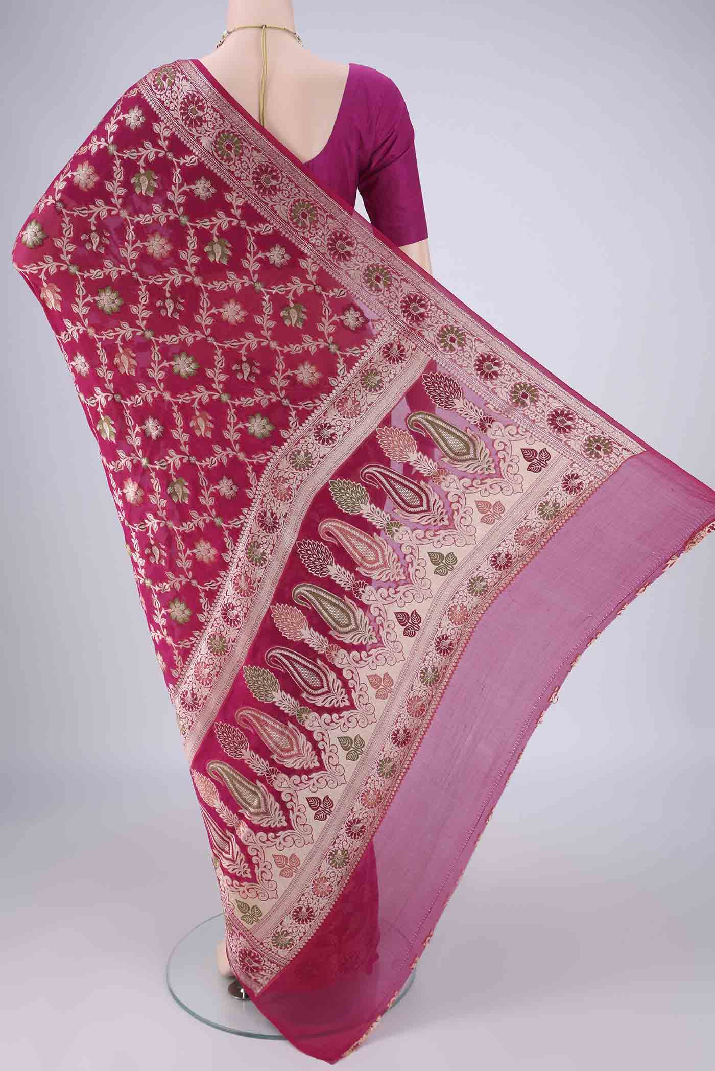 Flat view of Rani Pink Blended Banarasi Georgette Saree with Thread Brocade on the body and Zari And Thread Border. 