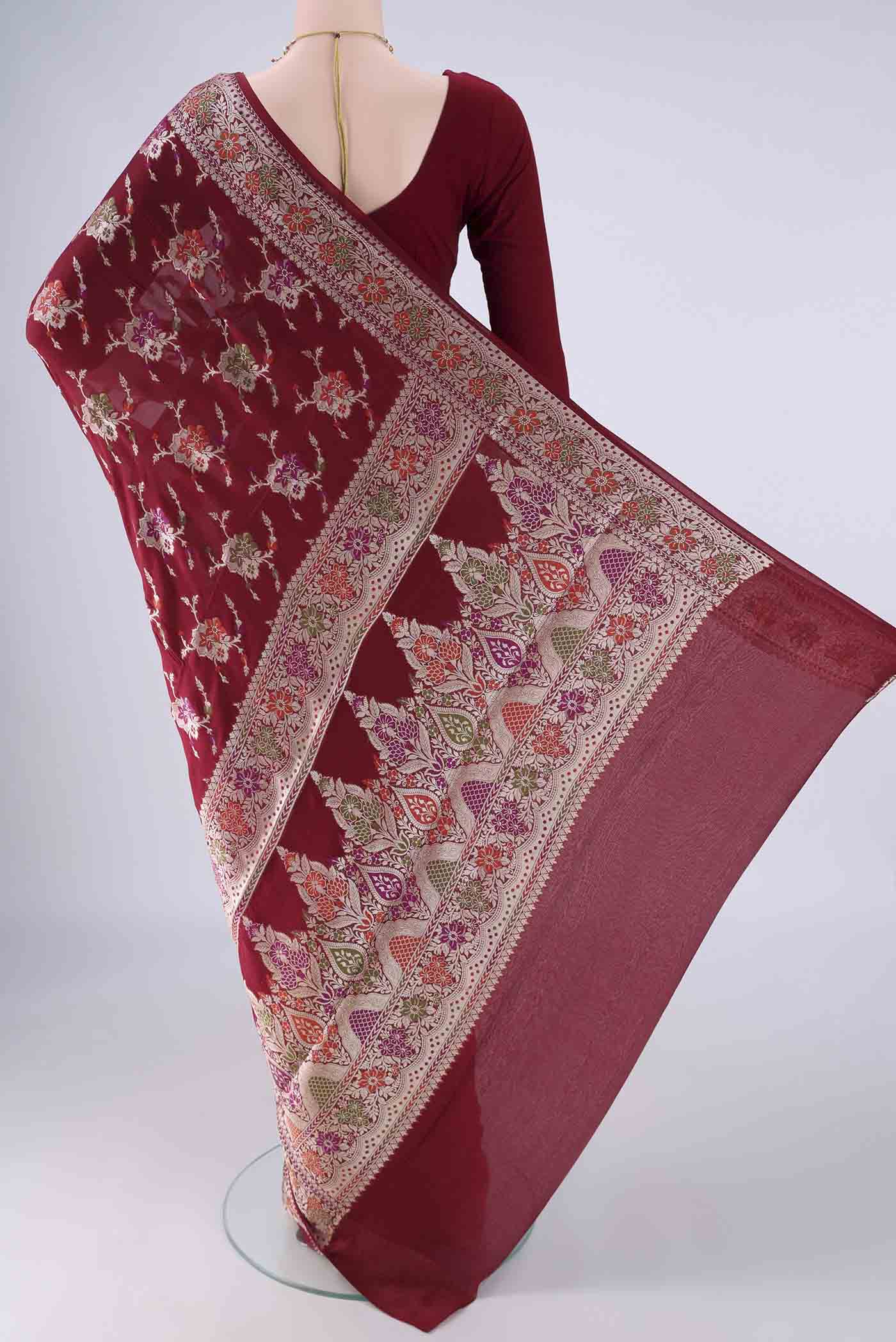 Flat view of Maroon Blended Banarasi Georgette Saree with Zari And Thread Butta on the body and Zari And Thread Border. 