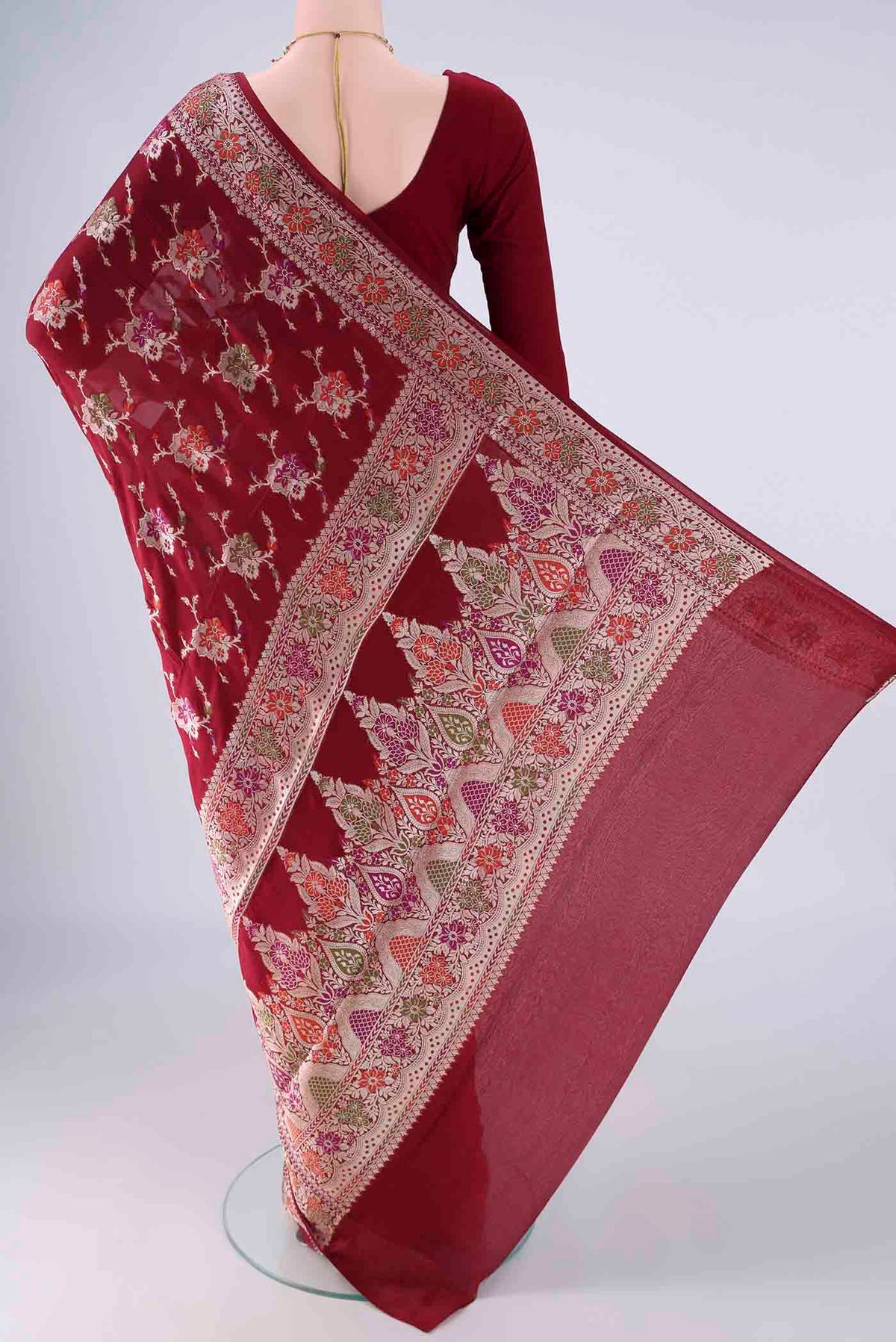 Flat view of Maroon Blended Banarasi Georgette Saree with Zari And Thread Butta on the body and Zari And Thread Border. 