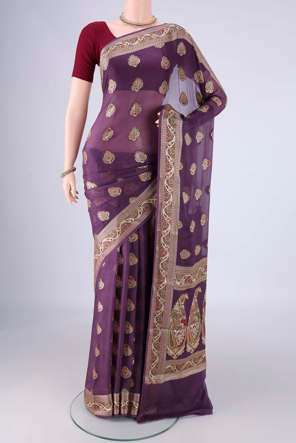Purple Blended Banarasi Georgette Saree with Zari And Thread Butta on the body and Zari And Thread Border.  displayed on a mannequin