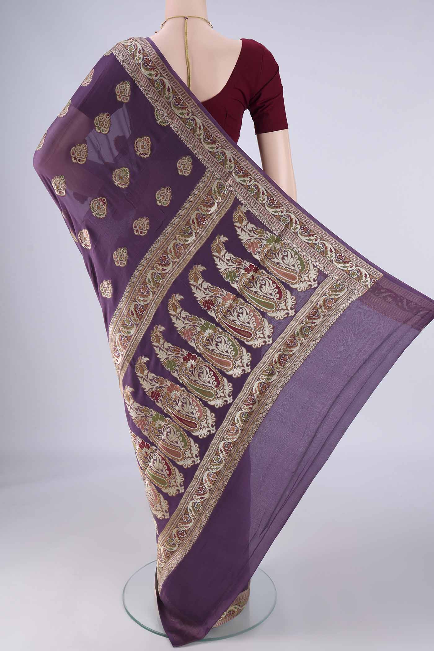 Flat view of Purple Blended Banarasi Georgette Saree with Zari And Thread Butta on the body and Zari And Thread Border. 