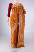 Mustard Blended Banarasi Georgette Saree with Zari And Thread Butta on the body and Zari And Thread Border.  displayed on a mannequin