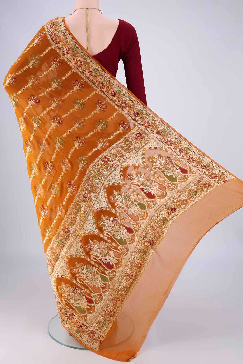 Flat view of Mustard Blended Banarasi Georgette Saree with Zari And Thread Butta on the body and Zari And Thread Border. 
