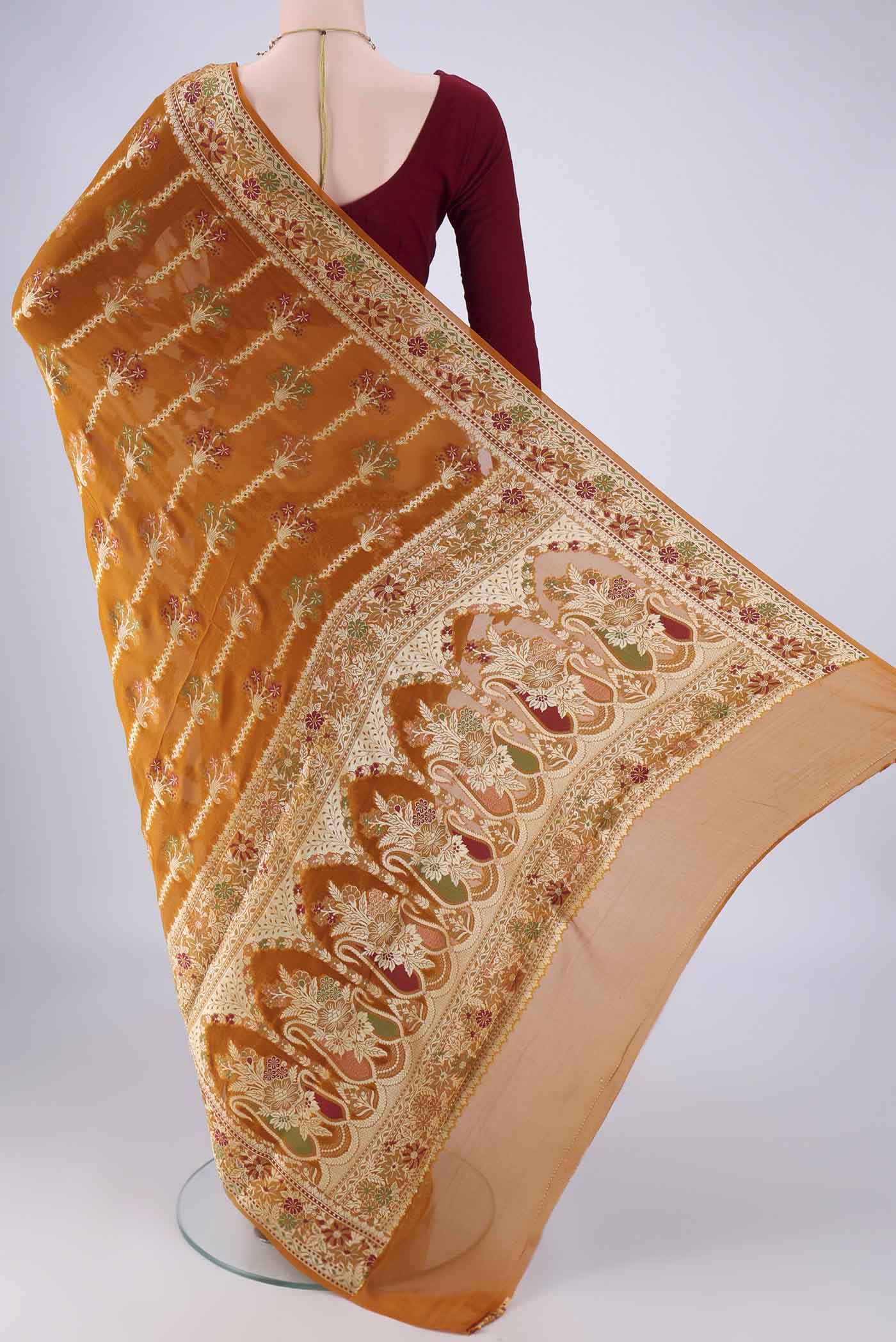 Flat view of Mustard Blended Banarasi Georgette Saree with Zari And Thread Butta on the body and Zari And Thread Border. 