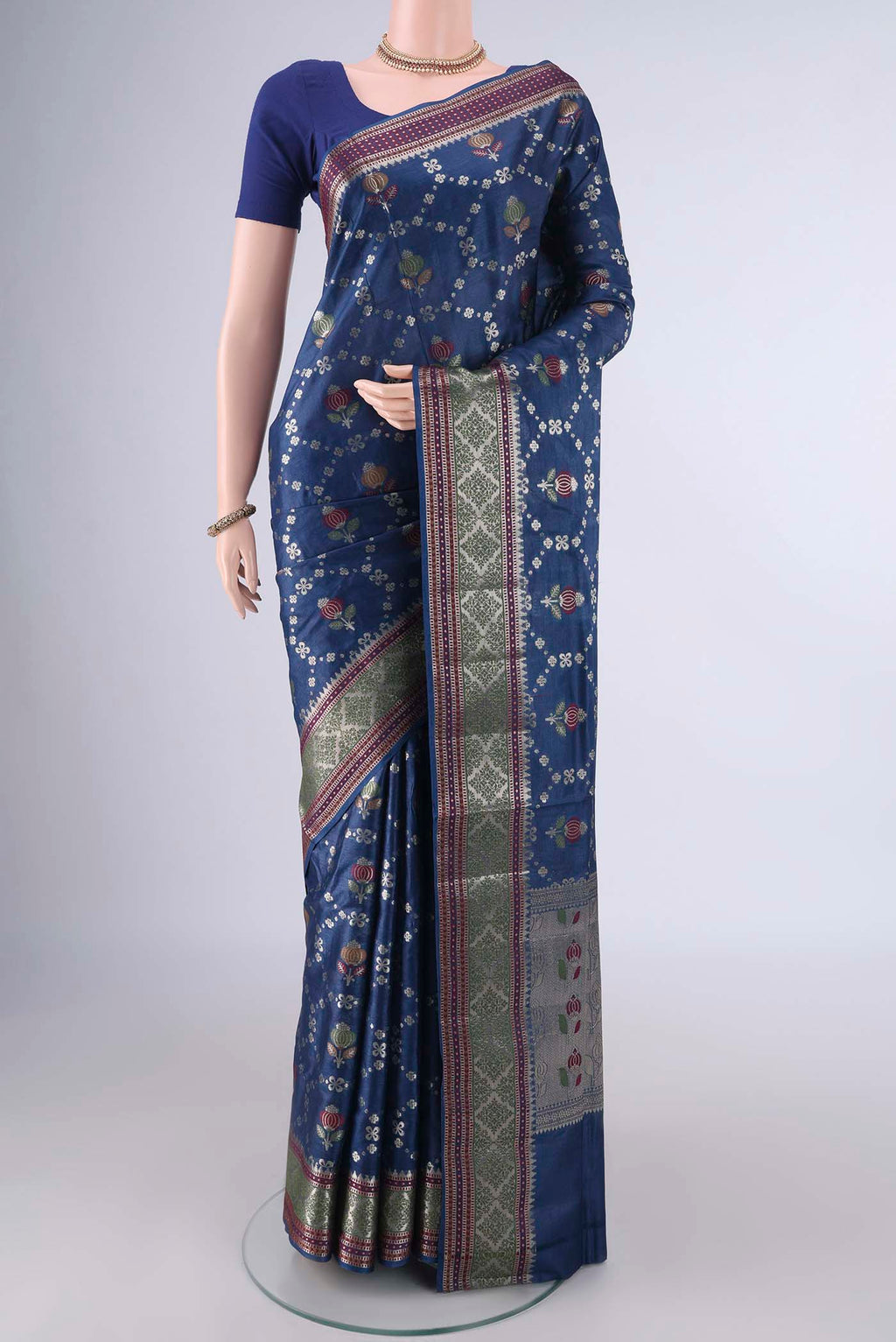 Blue Banarasi Tussar Saree with Zari And Thread Butta on the body and Zari And Thread Border.  displayed on a mannequin