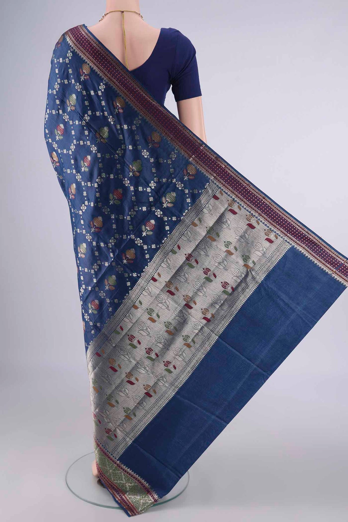 Flat view of Blue Banarasi Tussar Saree with Zari And Thread Butta on the body and Zari And Thread Border. 