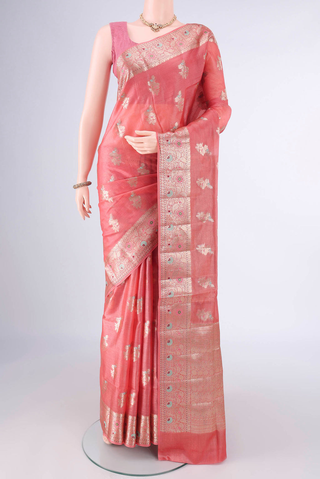 Peach Banarasi Tussar Saree with Zari And Thread Butta on the body and Zari And Thread Border.  displayed on a mannequin