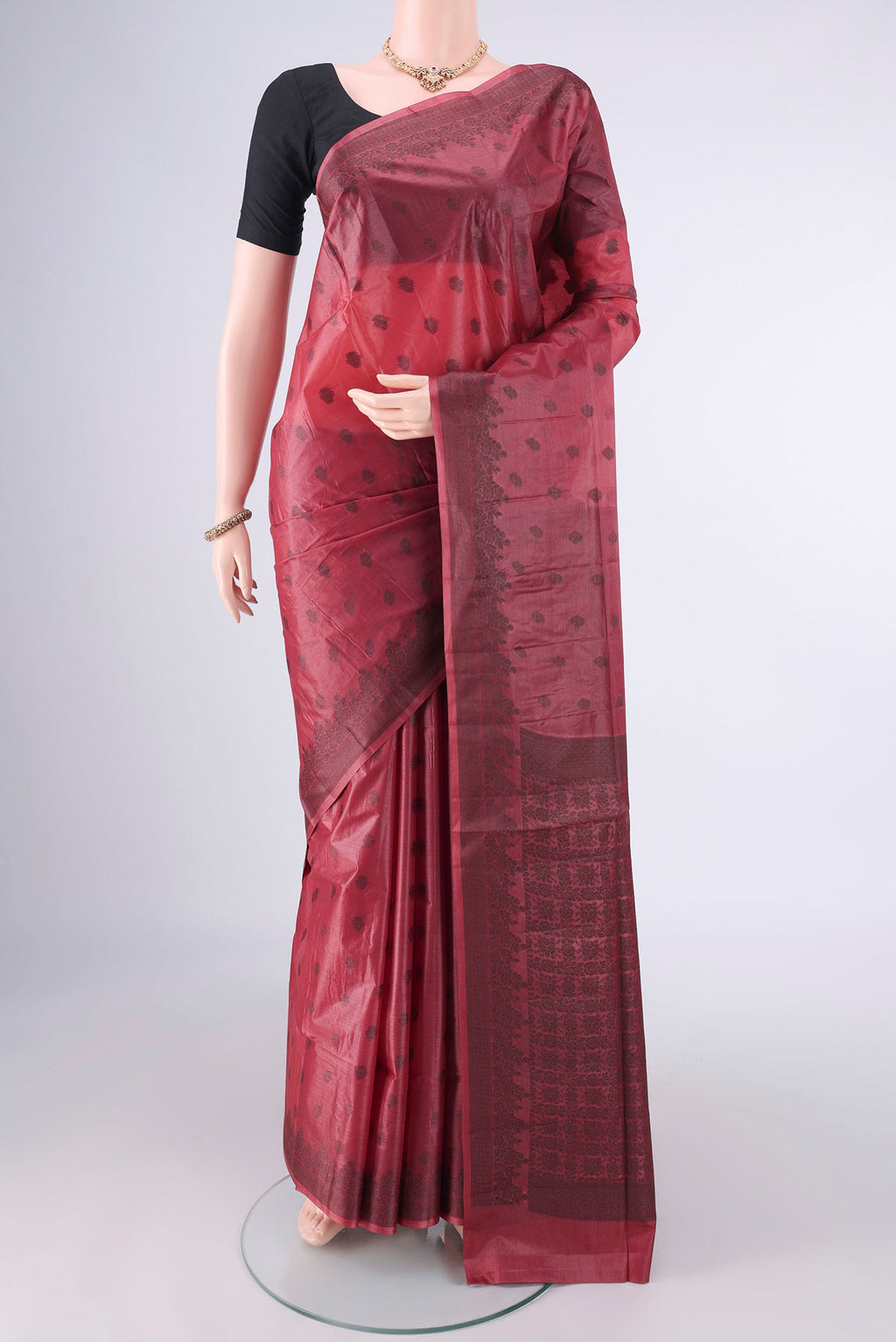 Coral Banarasi Tussar Saree with Thread Butta on the body and Thread Border.  displayed on a mannequin