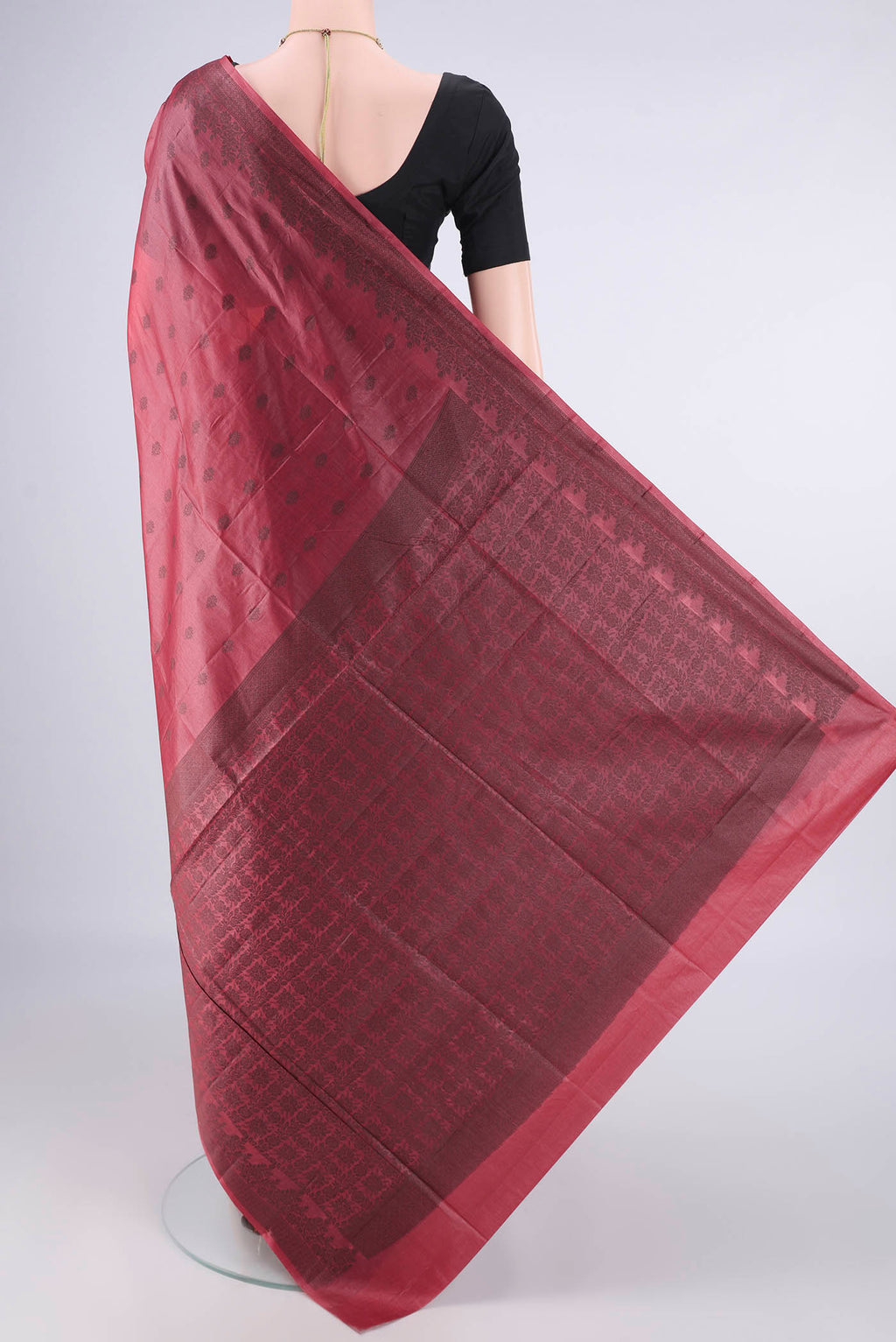 Flat view of Coral Banarasi Tussar Saree with Thread Butta on the body and Thread Border. 