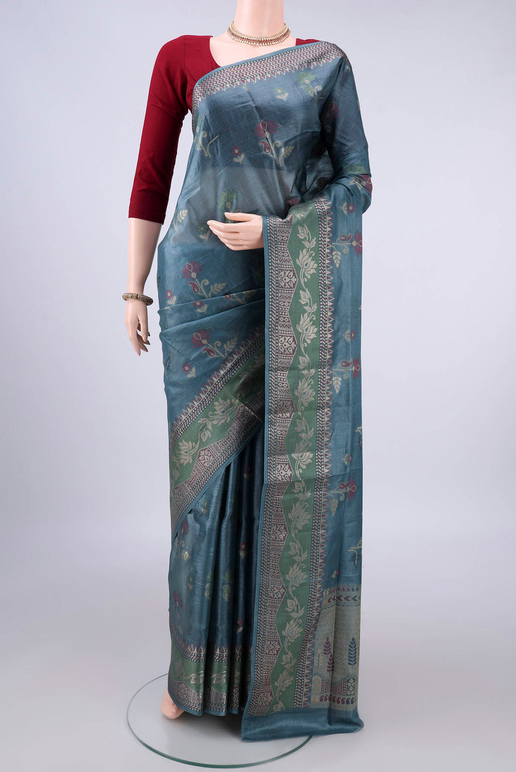 Maya Blue Banarasi Tussar Saree with Thread Butta on the body and Thread Border.  displayed on a mannequin