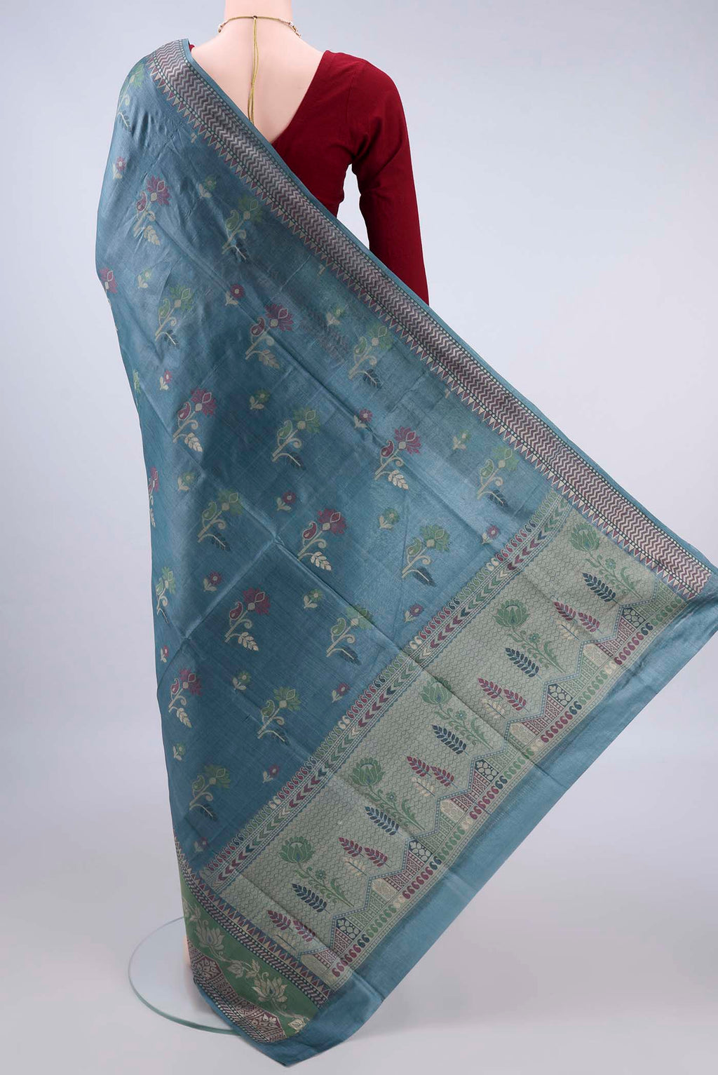 Flat view of Maya Blue Banarasi Tussar Saree with Thread Butta on the body and Thread Border. 