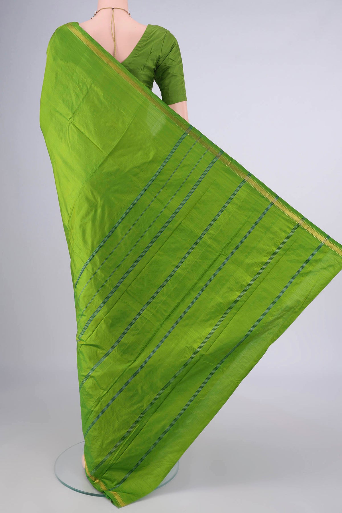 Flat view of Pure Silk Parrot Green Kanchipuram Saree with Plain Body and Zari Border. 