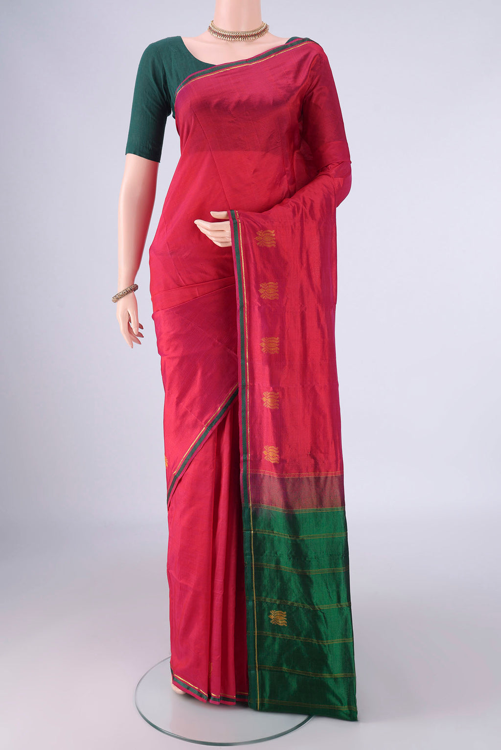 Maroon Kanchipuram Silk Saree with Plain Body and Thread Border.  displayed on a mannequin