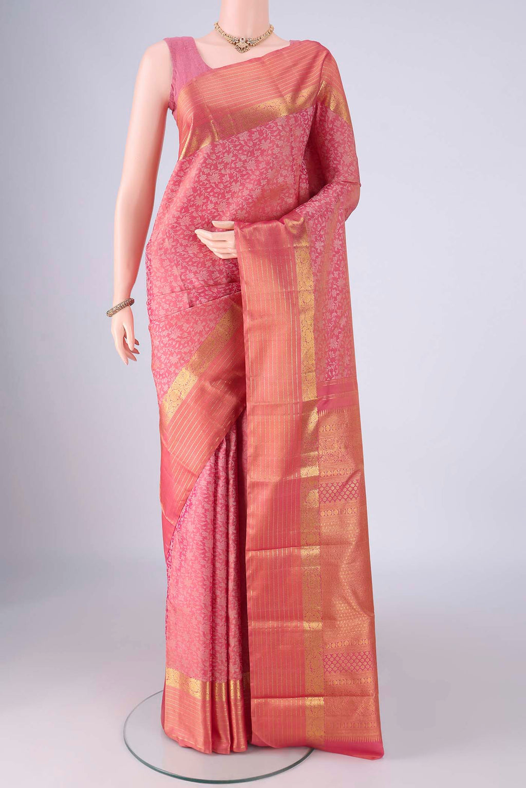 Rose pink Kanjivaram Silk Saree with Jacquard design on the body and Zari Border.  displayed on a mannequin