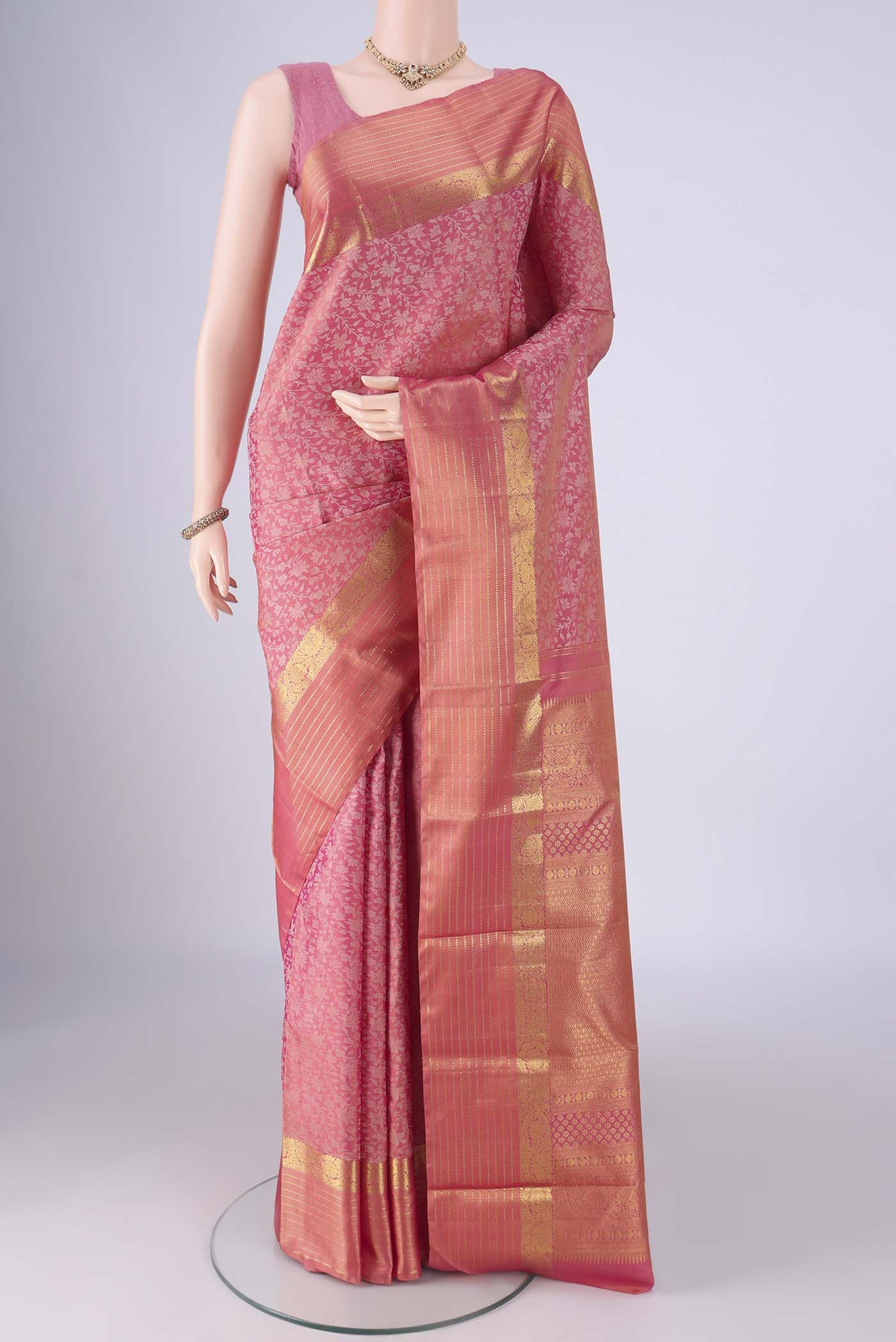 Rose pink Kanjivaram Silk Saree with Jacquard design on the body and Zari Border.  displayed on a mannequin