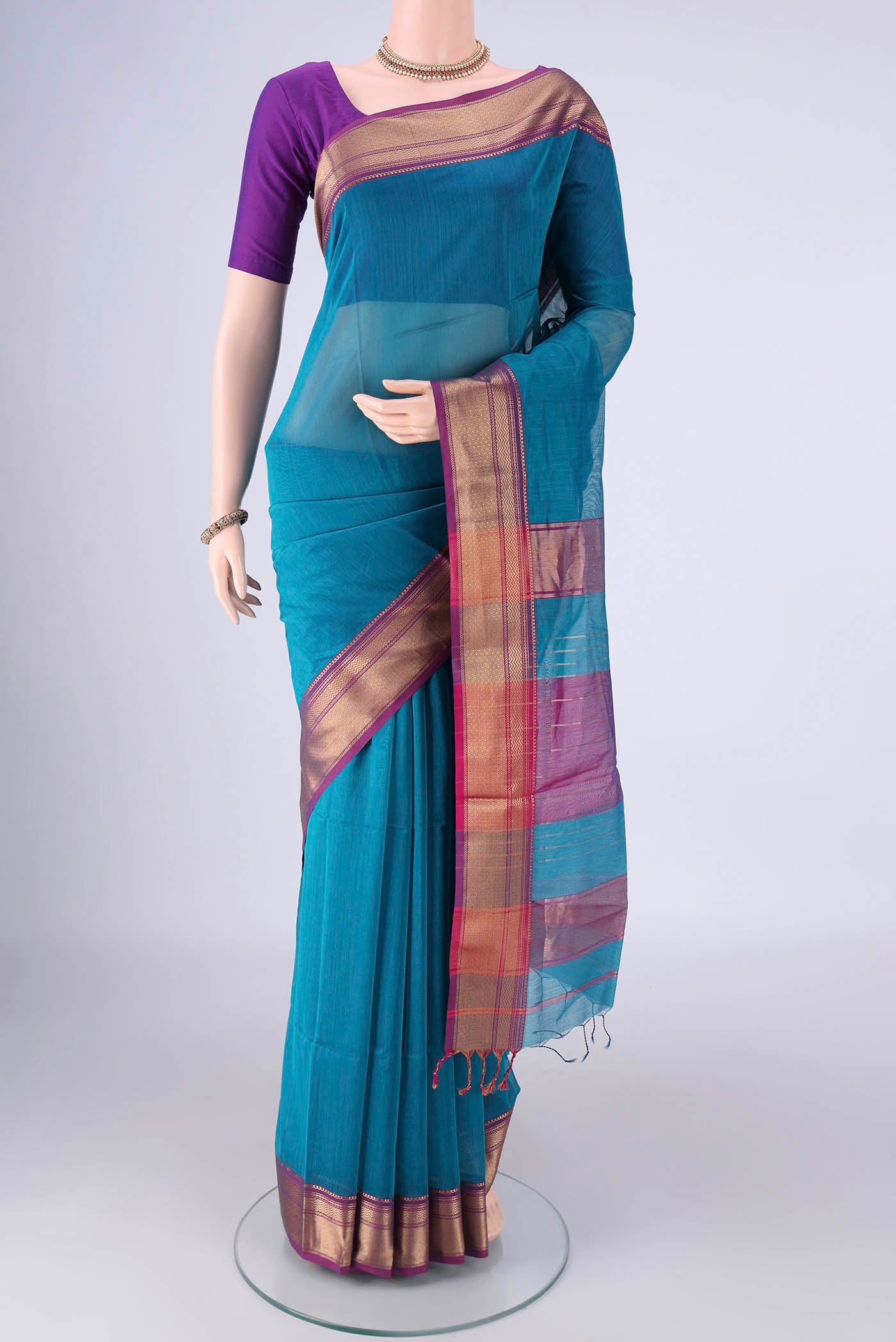 Blue Maheshwari Silk Cotton Saree with Plain Body and Zari Border.  displayed on a mannequin