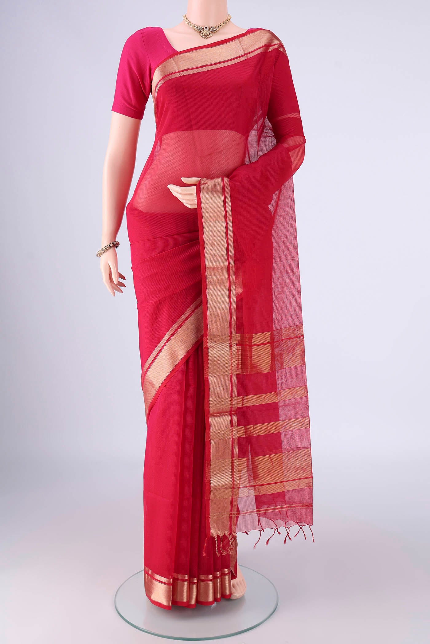 Dark Pink Maheshwari Silk Cotton Saree with Stripes on the body and Zari Border.  displayed on a mannequin