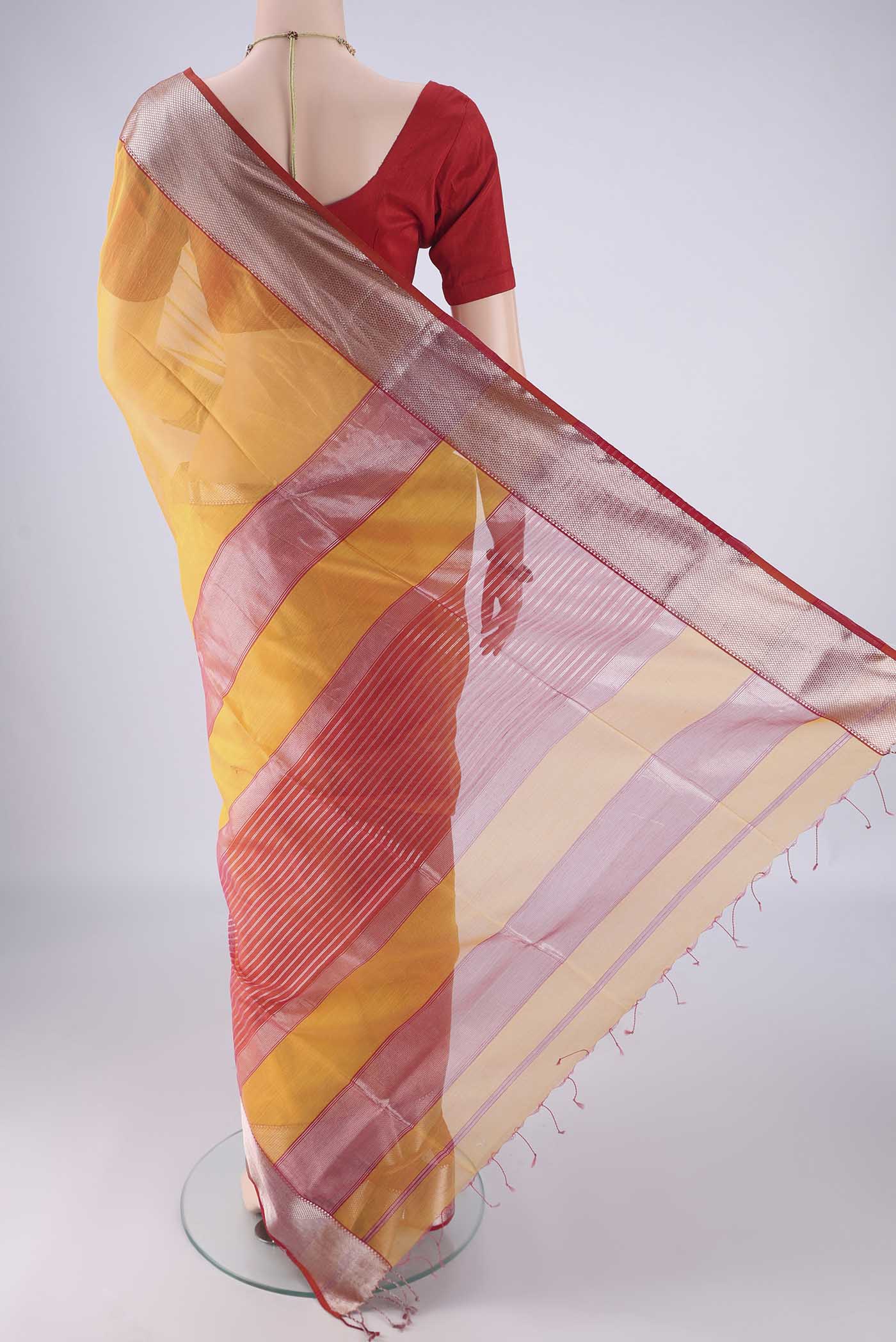 Flat view of Yellow Maheshwari Silk Cotton Saree with Plain Body and Zari Border. 