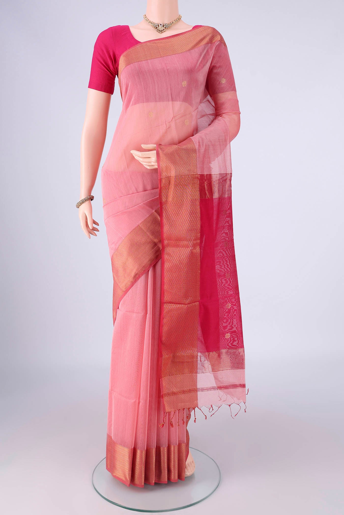 Rose pink Maheshwari Silk Cotton Saree with Zari Butta on the body and Zari Border.  displayed on a mannequin